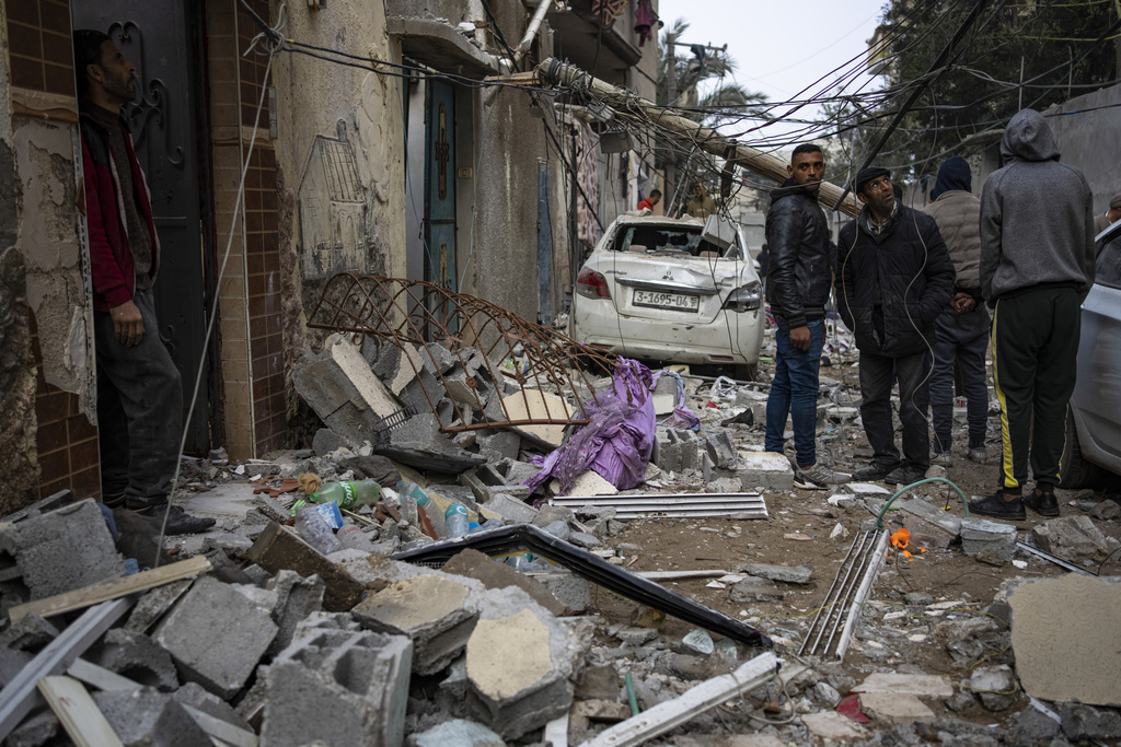 Palestinians look at the destruction after an Israeli airstrike in Rafah, Gaza Strip, Friday, Feb. 9, 2024.