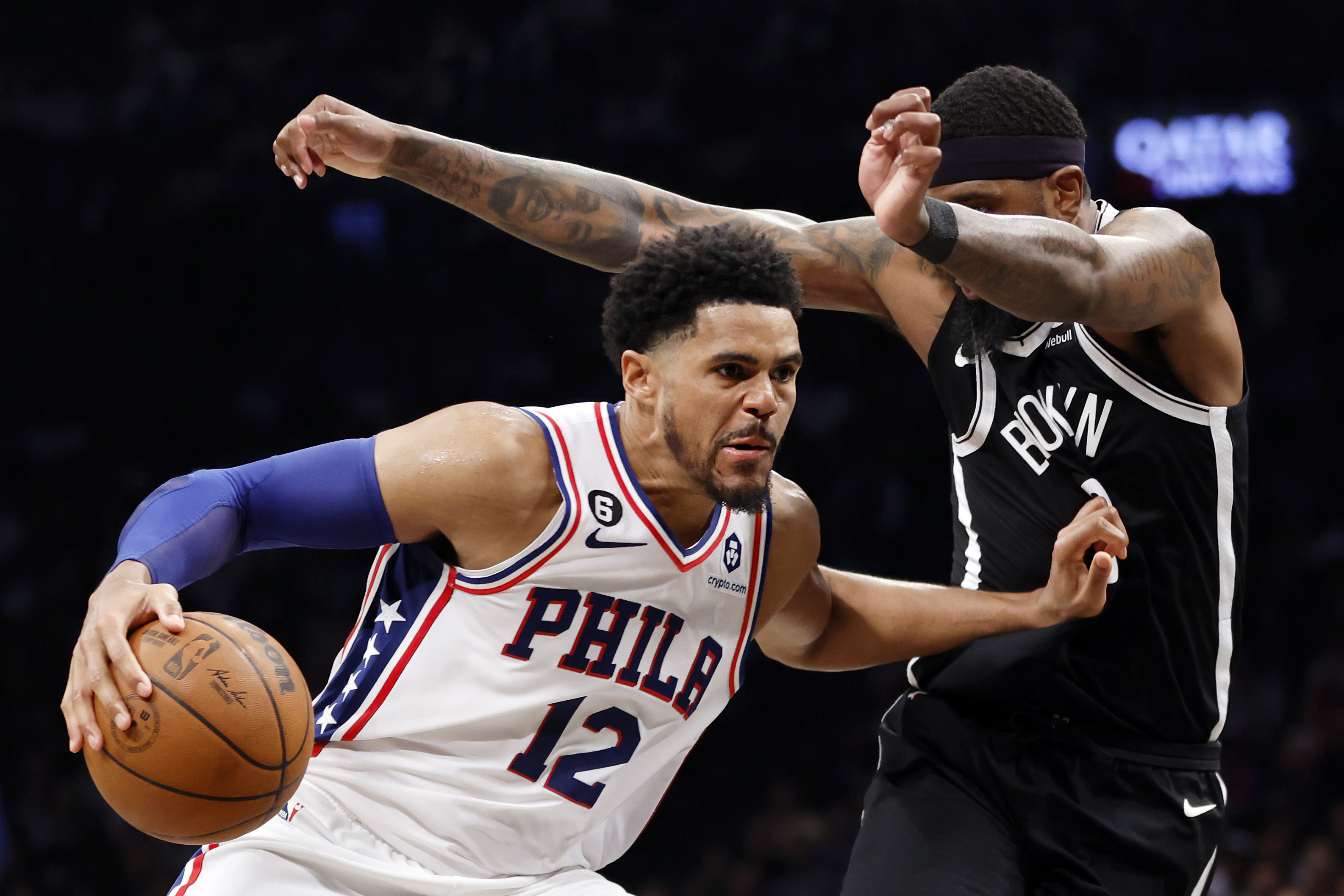 Tobias Harris #12 of the Philadelphia 76ers dribbles against Royce O'Neale #00 of the Brooklyn Nets during the second half of Game Four of the Eastern Conference First Round Playoffs at Barclays Center on April 22, 2023 in the Brooklyn borough of New York City. The 76ers won 96-88. 