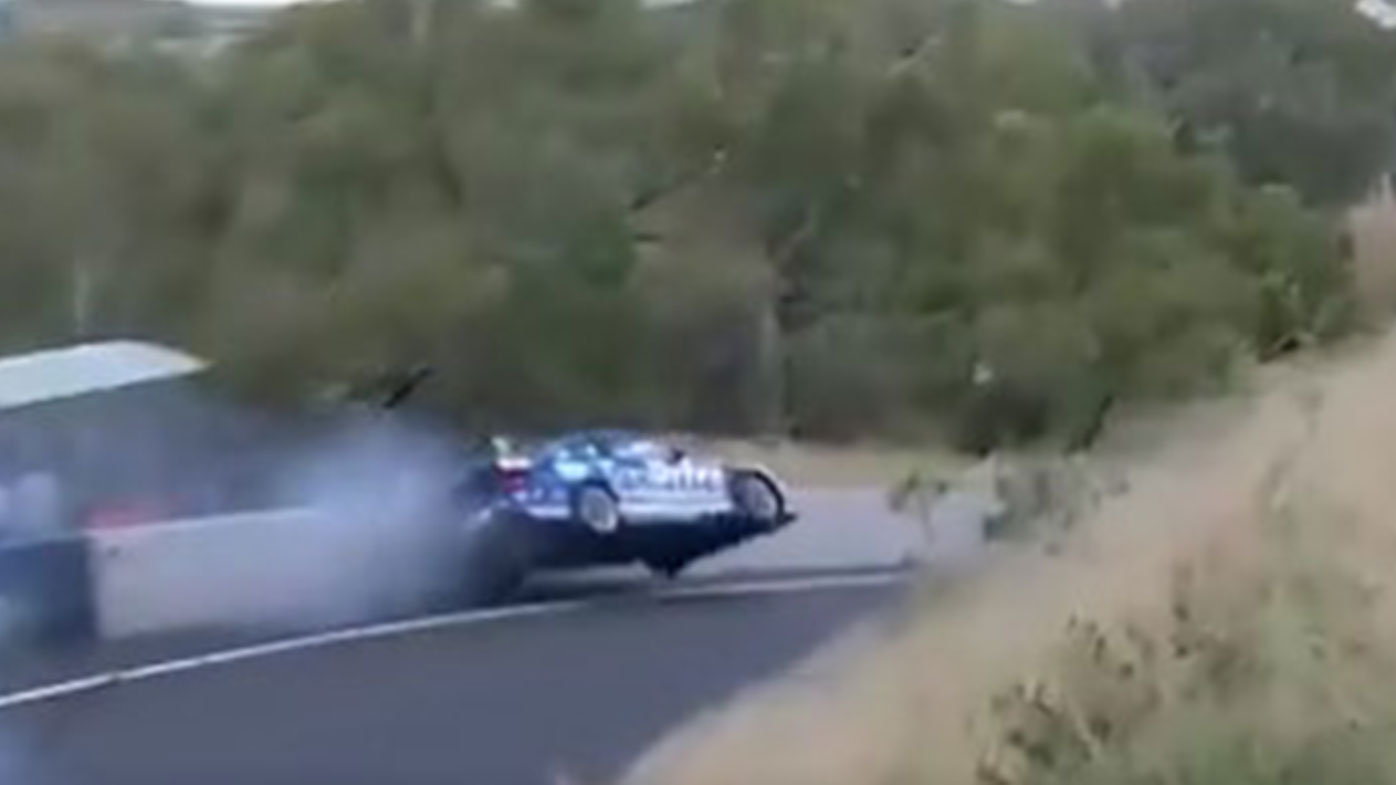 Tim Slade hits the wall on the approach to Forrest's Elbow during the opening race of the Supercars season at Bathurst.