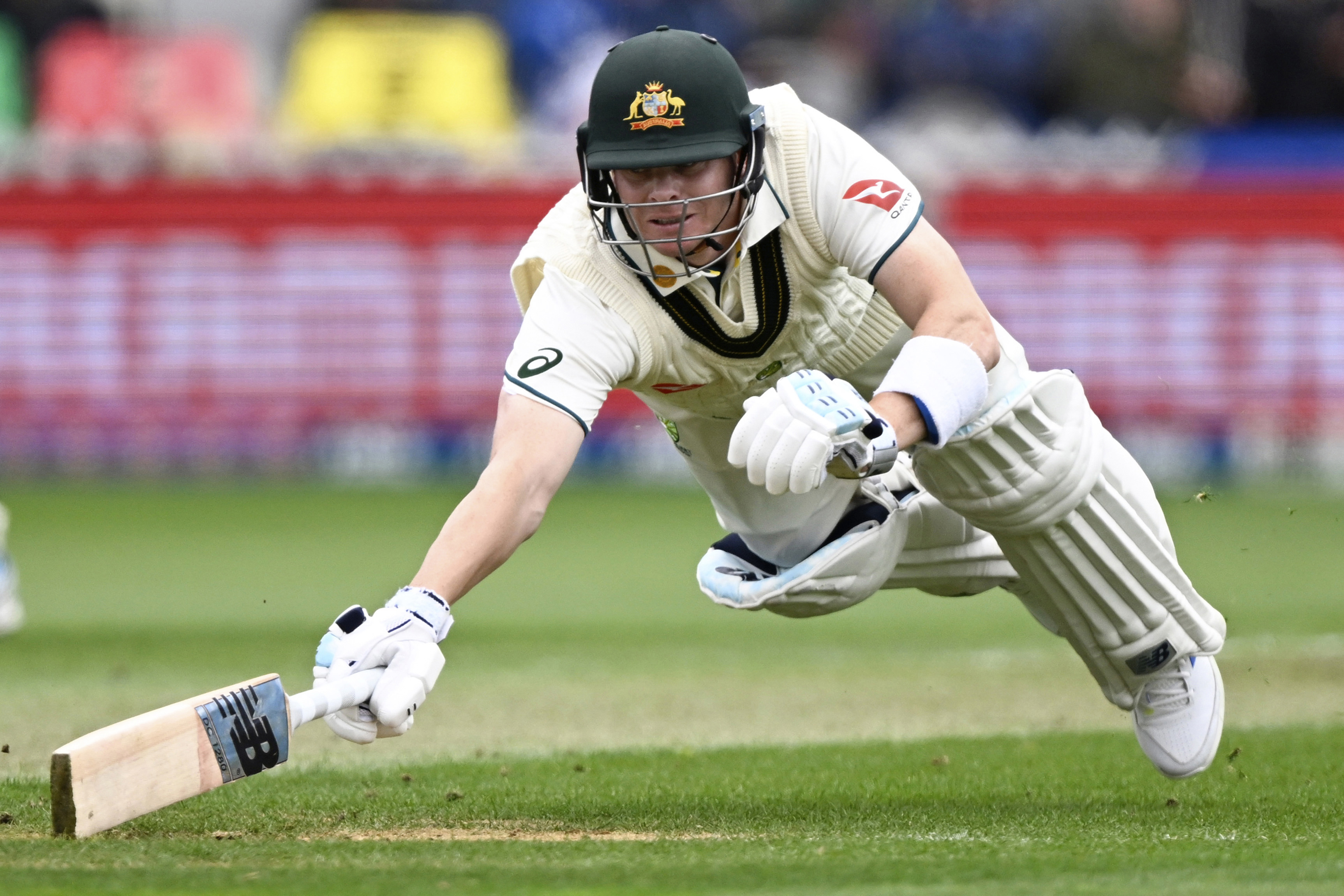 Australia's Steve Smith dives to make his ground while batting against New Zealand on the first day of their cricket test match in Wellington,