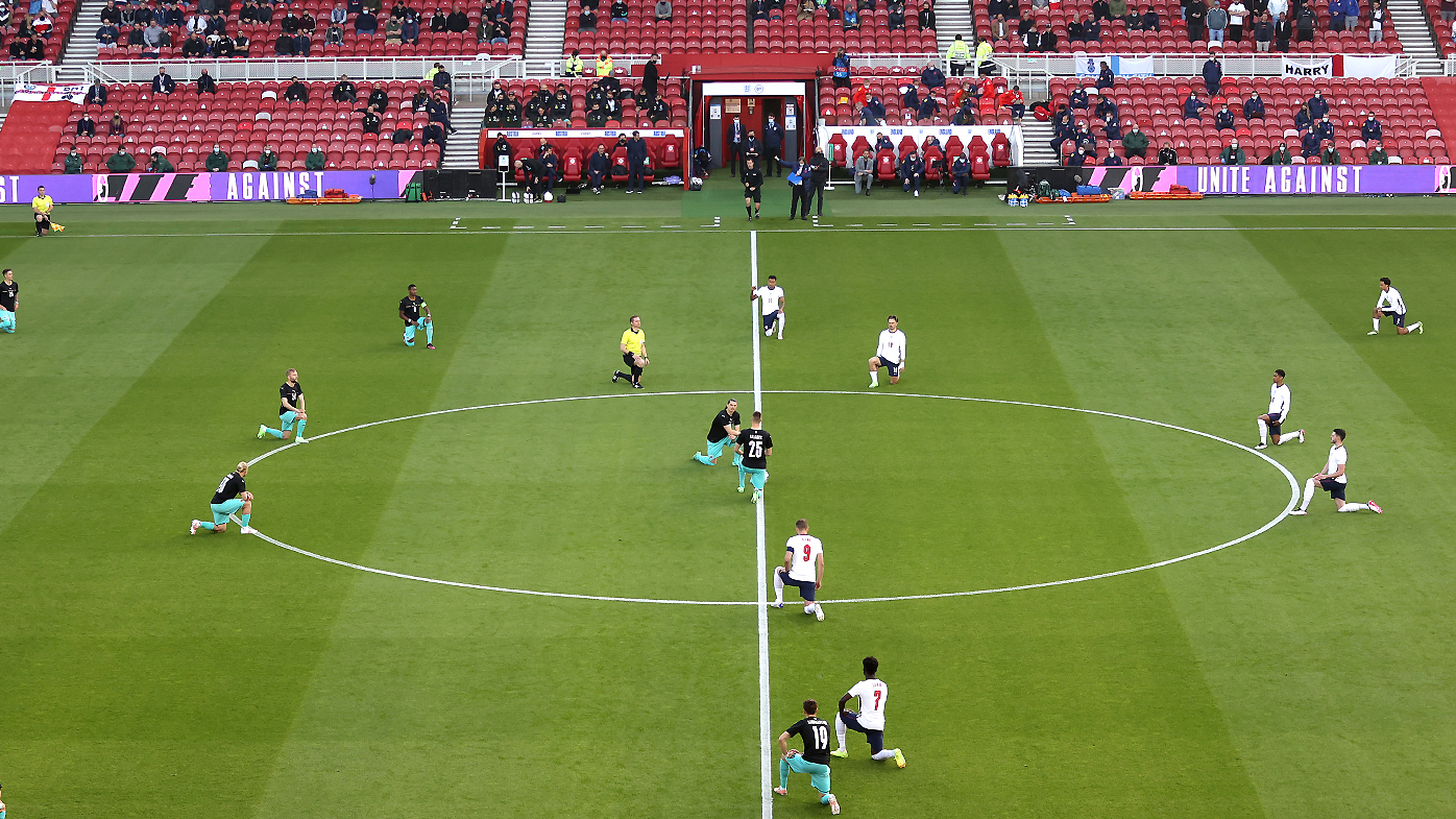 Players and officials take a knee in support of the black lives matter movement during the international friendly match between England and Austria 