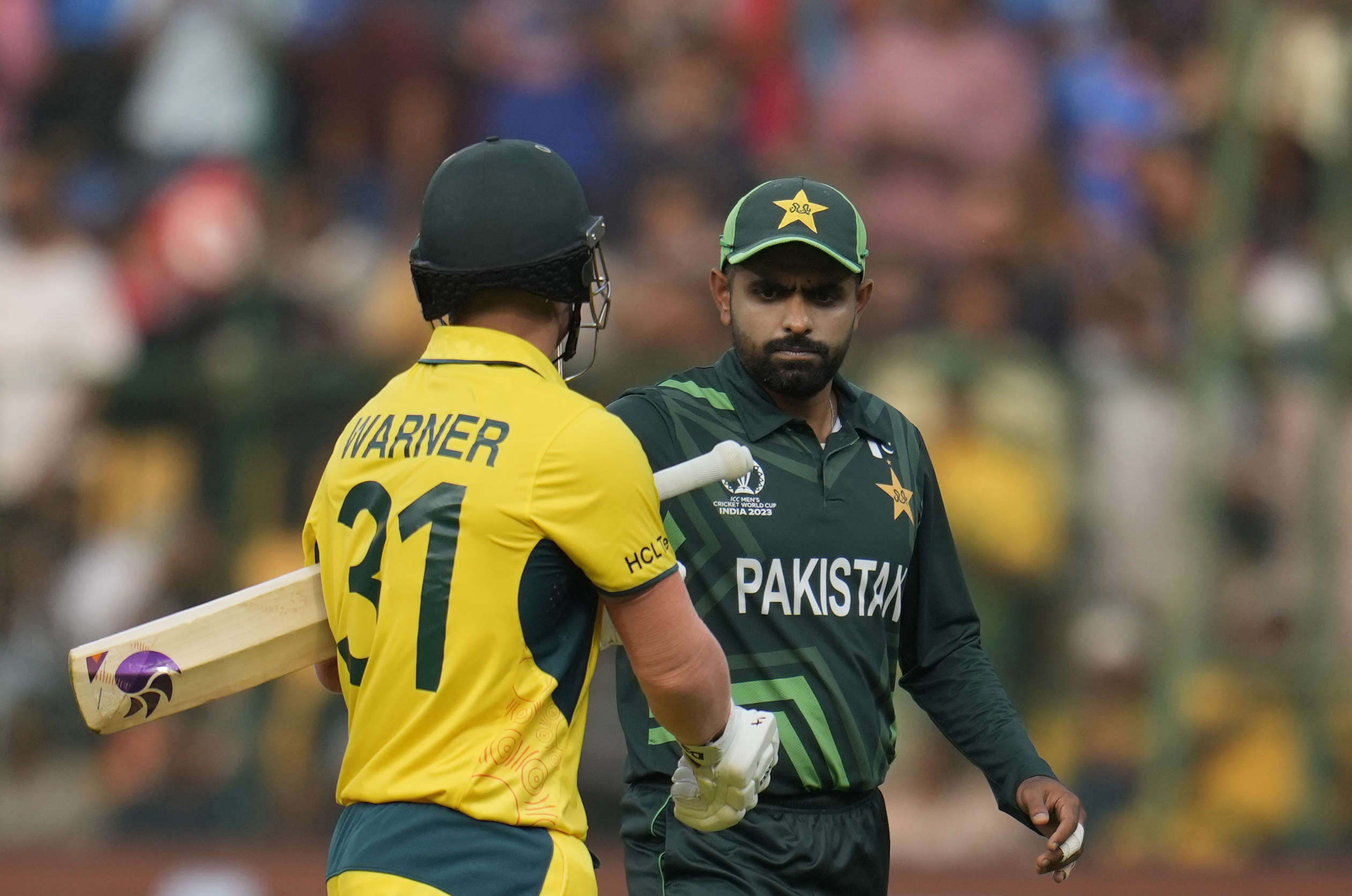 Pakistan's captain Babar Azam congratulates Australia's David Warner on his fine innings after Warner got out during the ICC Men's Cricket World Cup match between Australia and Pakistan in Bengaluru, India, Friday, Oct. 20, 2023. (AP Photo/Aijaz Rahi)