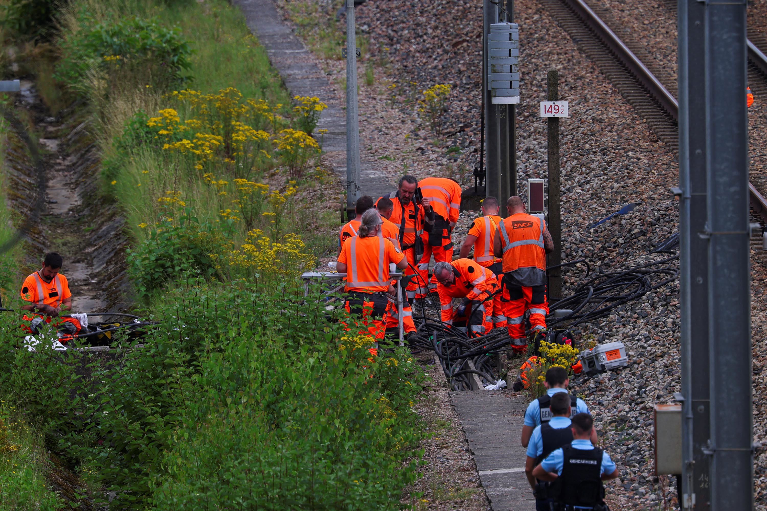 SNCF railway staff and police officers work at the site where vandals targeted France's high-speed train network in Croisilles, France, on July 26.