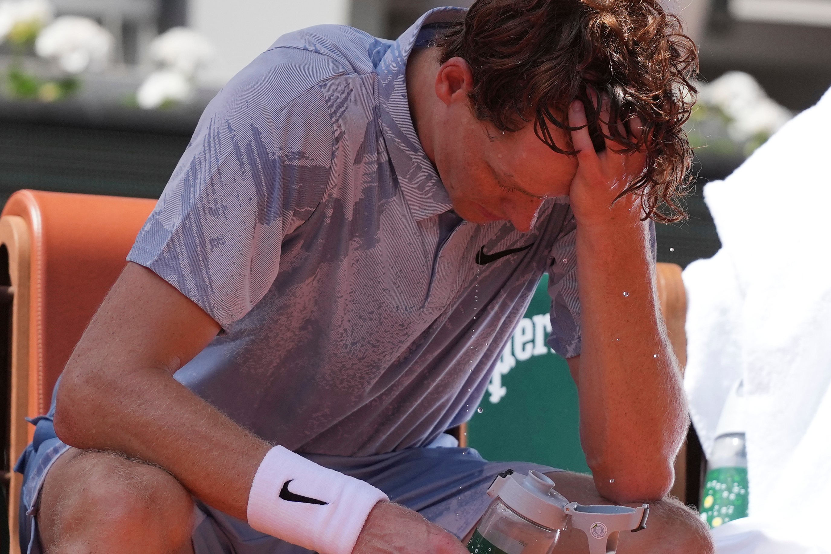 Jannik Sinner of Italy cools himself with the water during a break.