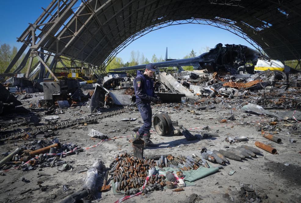 A Ukrainian sapper searches for unexploded explosives at the remains of the Antonov An-225, the world's biggest cargo aircraft destroyed during recent fighting between Russian and Ukrainian forces, at the Antonov airport in Hostomel.