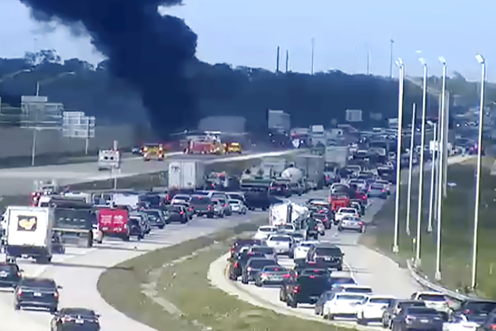 Florida Highway Patrol troopers are on the scene of a small airplane landing on southbound Interstate 75 in Naples, Fla., Friday, Feb. 9, 2024.