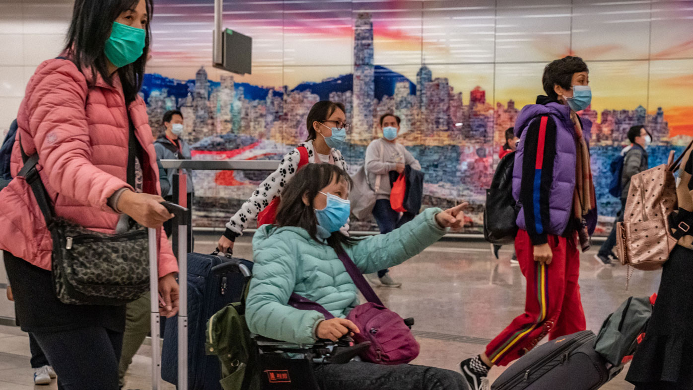 Travellers wearing protective masks exit the arrival hall at Hong Kong High Speed Rail Station amid the coronavirus outbreak.