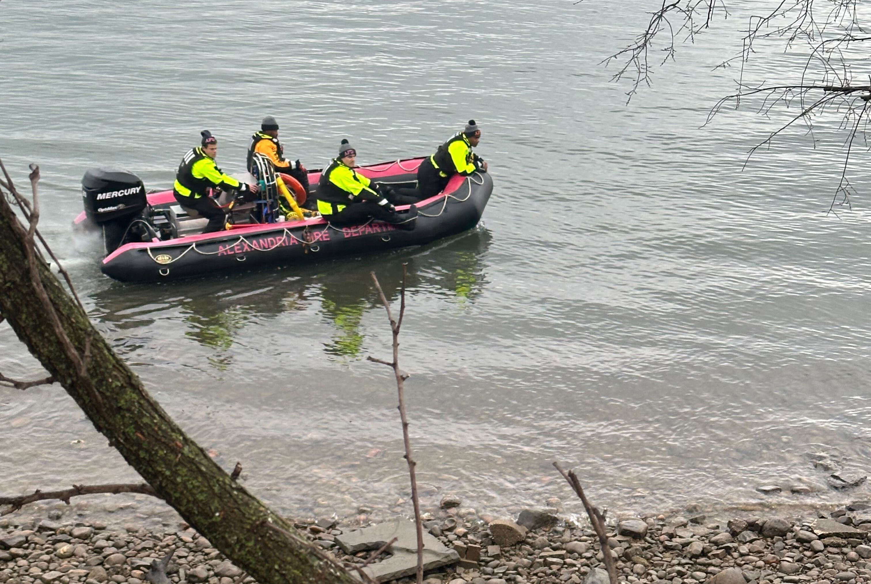 Members of the Alexandria Fire Department search for wreckage from the crash near Ronald Reagan Washington National Airport along the Potomac River in Alexandria, Va., Friday, Jan. 31, 2025. (AP Photo/Claudia Lauer)