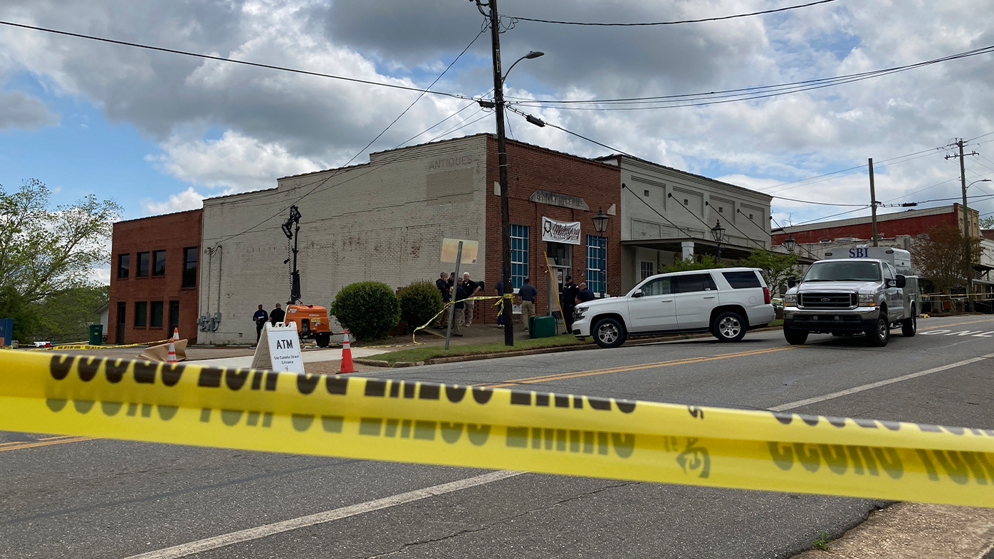 Investigators work at the site of a fatal shooting in downtown Dadeville, Ala., on Sunday, April 16, 2023.