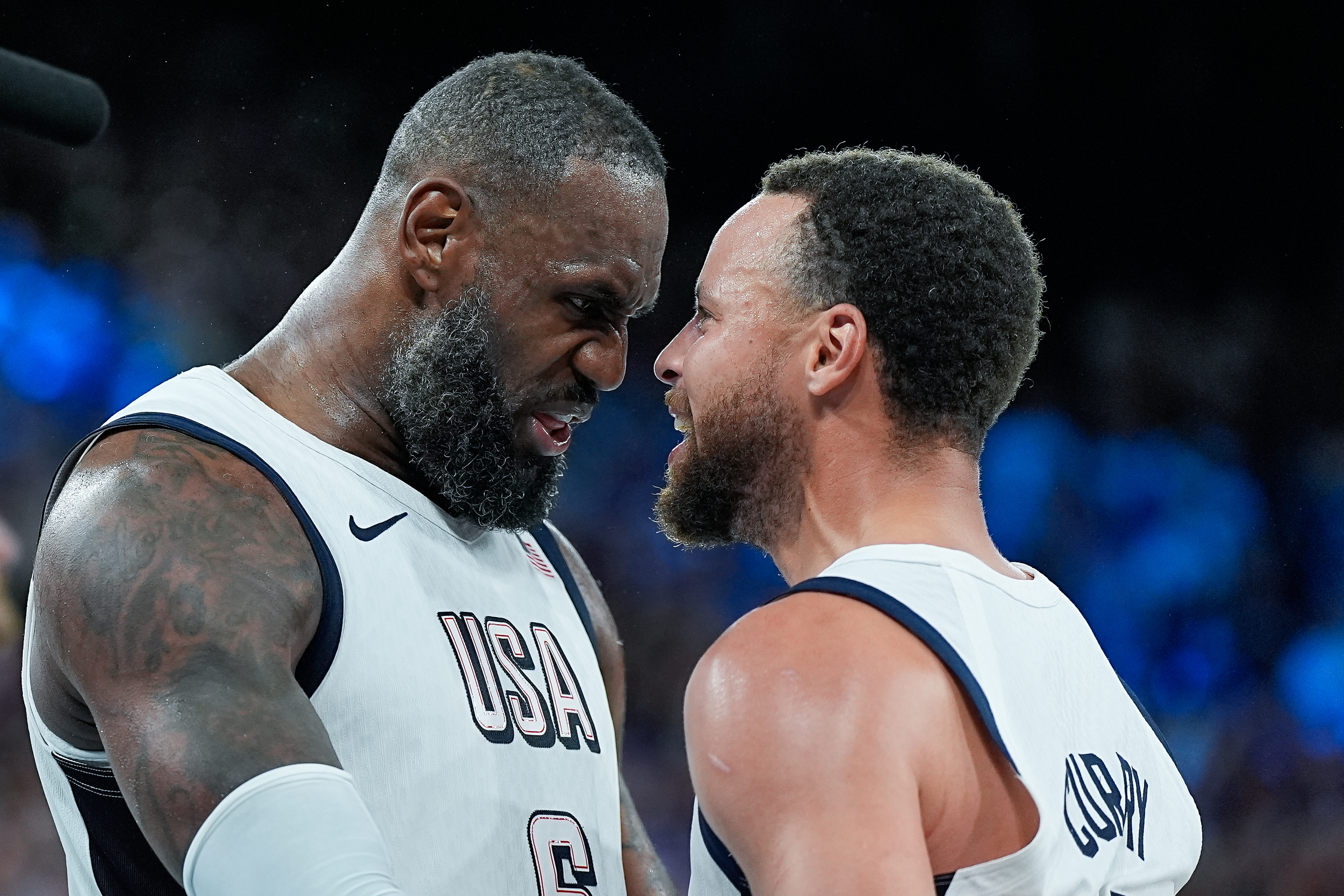 PARIS, FRANCE - AUGUST 8: Lebron James of United States and Stephen Curry of the United States celebrate their victory and entry into the Final at the final whistle during the Men's Semifinal Game between United States and Serbia on day thirteen of the Olympic Games Paris 2024 at Arena Bercy on August 8, 2024 in Paris, France. (Photo by Daniela Porcelli/Eurasia Sport Images/Getty Images)