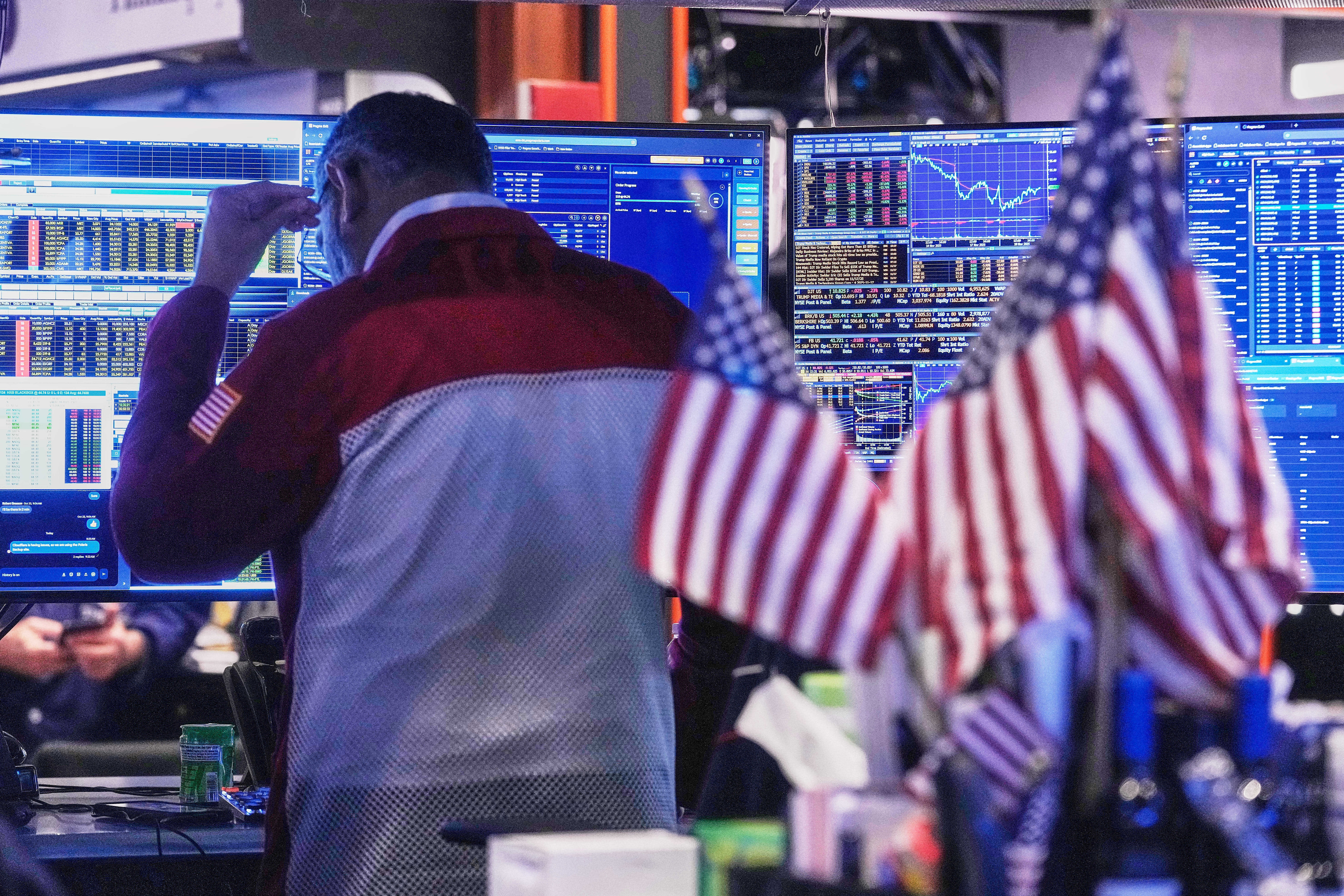 Trader Anan Patel works on the floor of the New York Stock Exchange, Tuesday, Nov. 18, 2025. (AP Photo/Richard Drew)