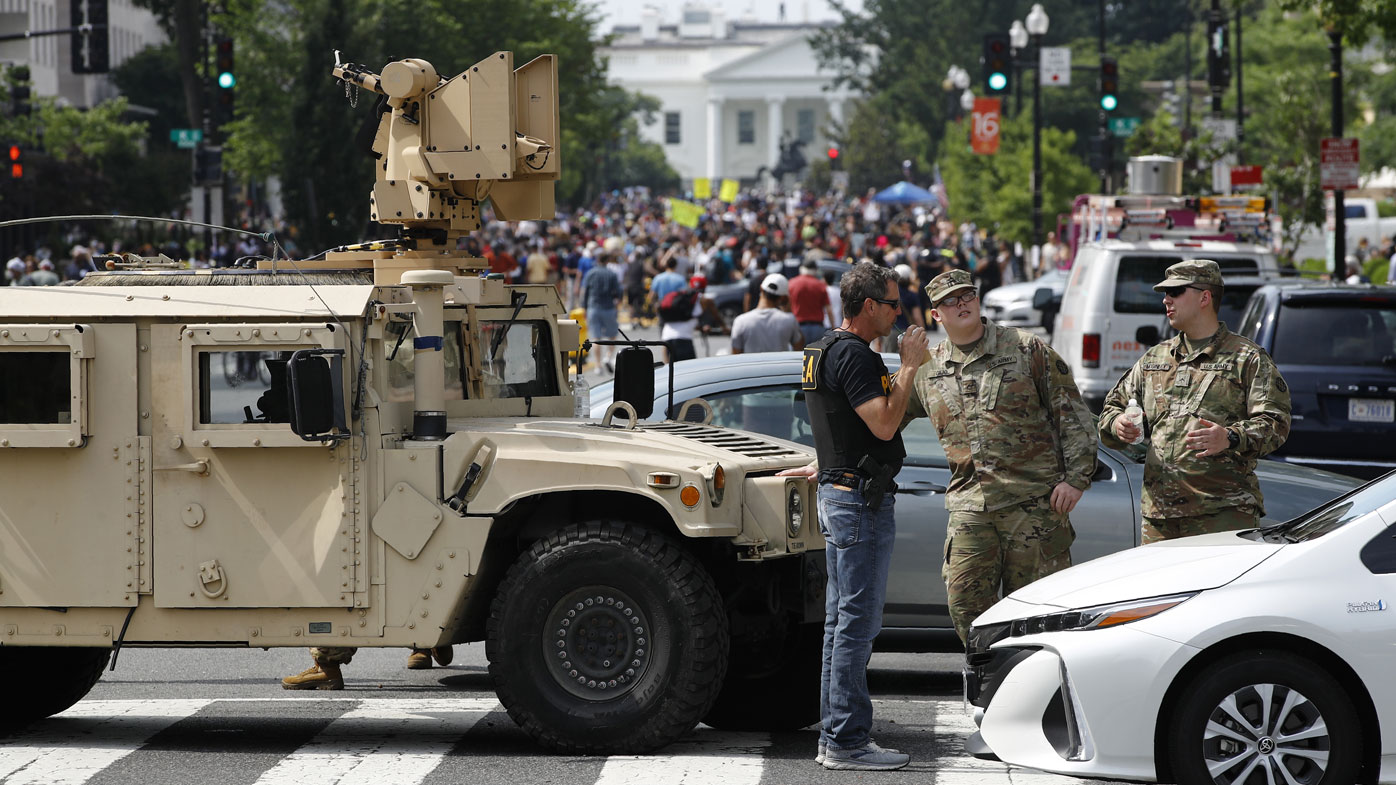 A checkpoint blocks traffic on 16th Street Northwest as people gather near the White House, Saturday, June 6, 2020
