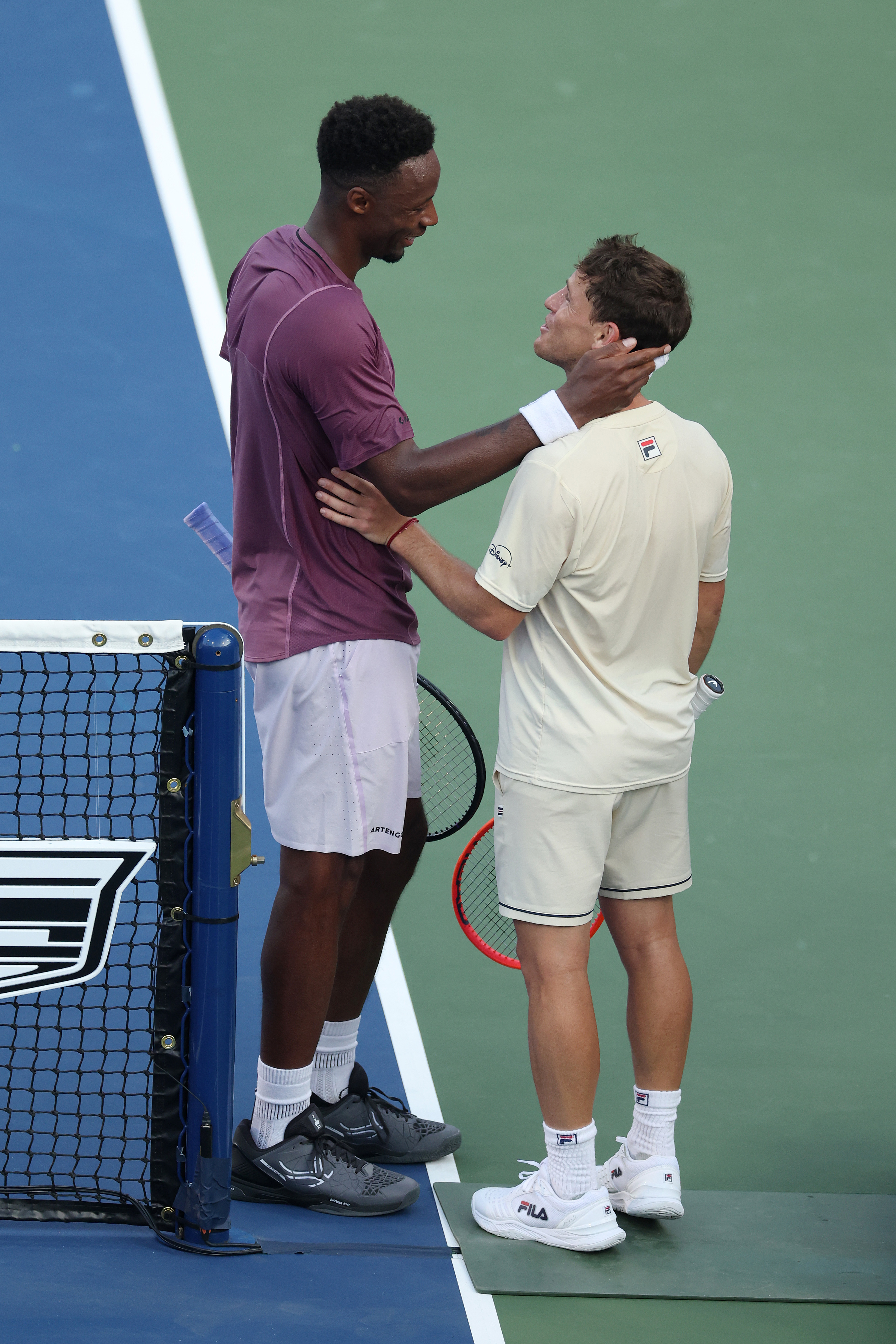 Gael Monfils of France talks with Diego Schwartzman of Argentina after their US Open clash.