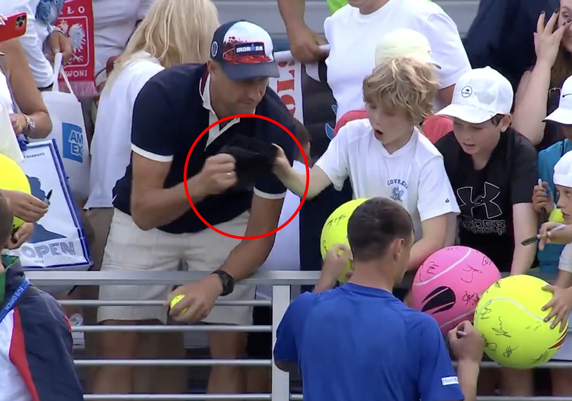 A man is caught on video snatching a match-worn cap from a young fan at the US Open.