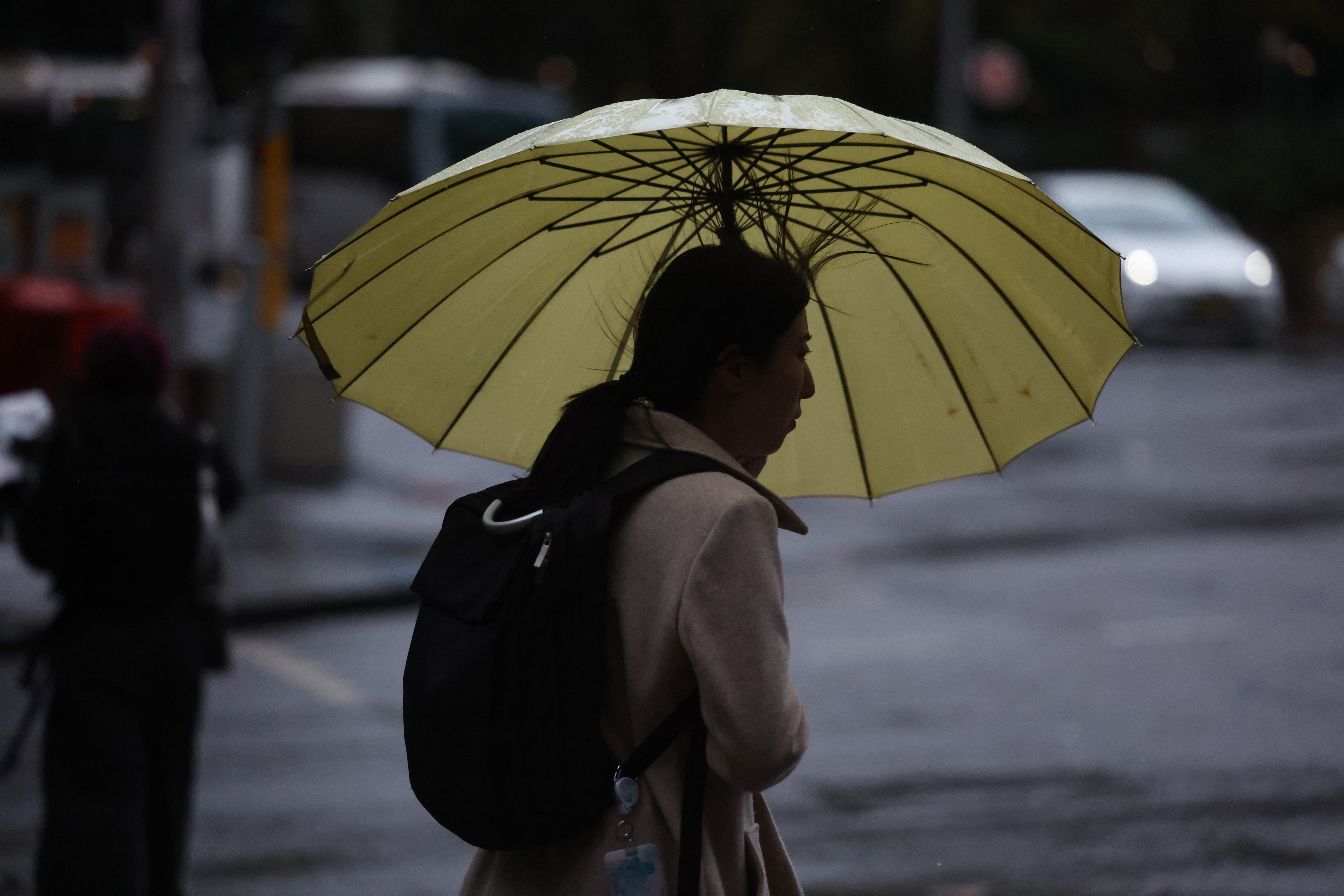 People are seen braving the rain on Friday, 23 May, 2025. The coastal trough responsible for bringing record rain to northern NSW has become more mobile after it was parked for days over soaked catchments. Picture - Sam Mooy / The Sydney Morning Herald
