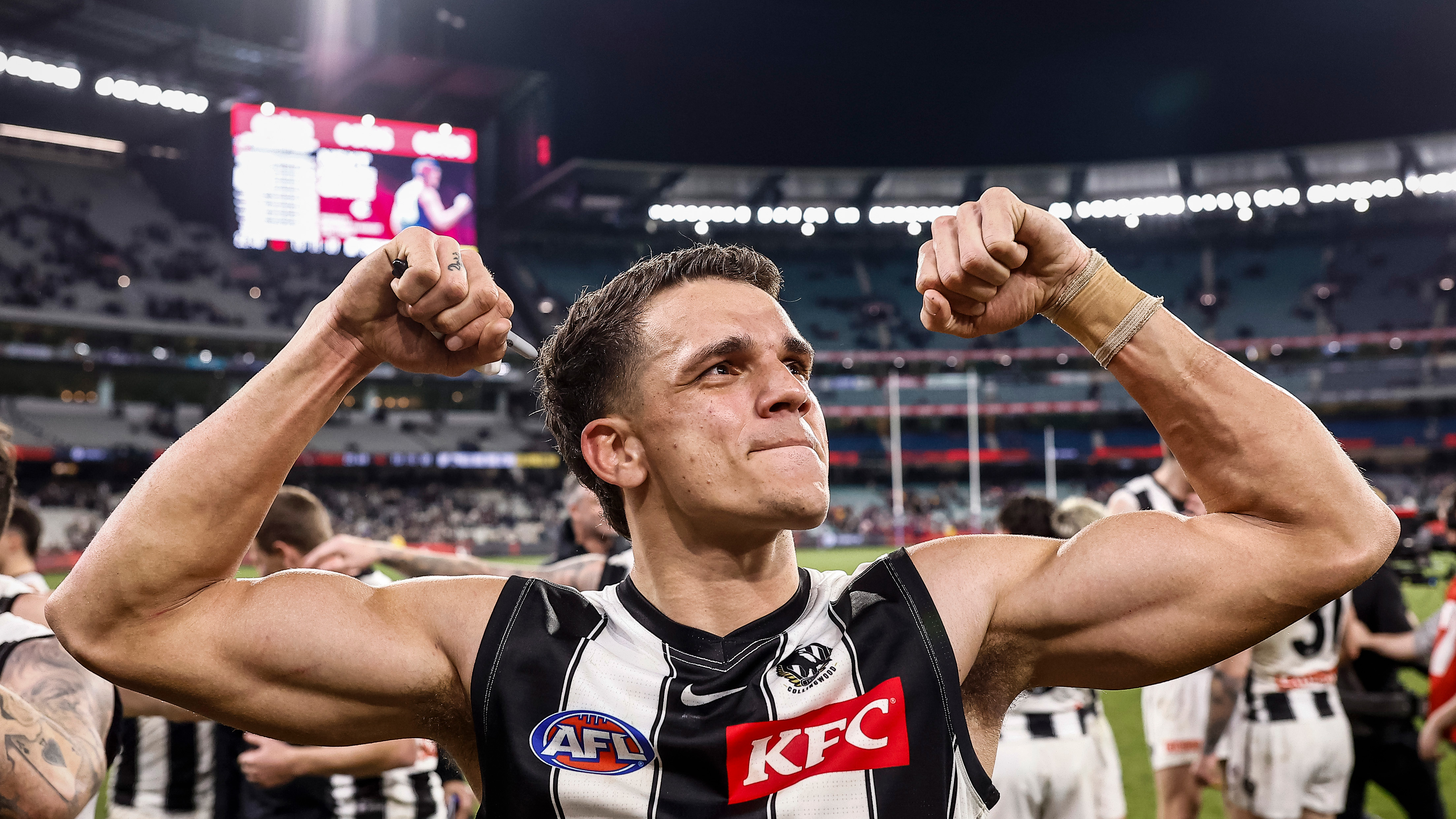 Ash Johnson of the Magpies acknowledges the fans after the round 21 AFL match between the Melbourne Demons and the Collingwood Magpies at Melbourne Cricket Ground on August 05, 2022 in Melbourne, Australia. (Photo by Darrian Traynor/Getty Images)