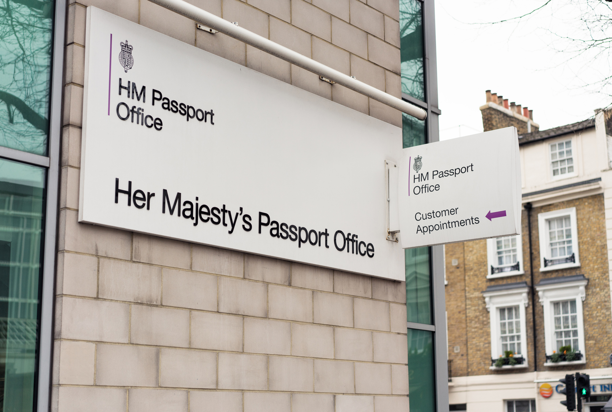 London, UK - Signs outside an HM Passport Office in the Victoria area of central London.