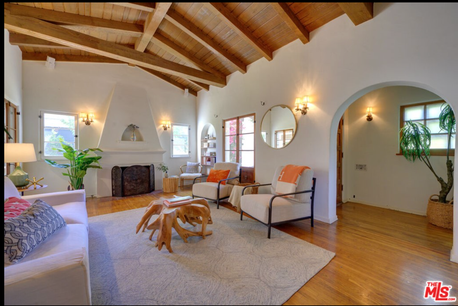 The living room of the home features a beamed vaulted ceiling.