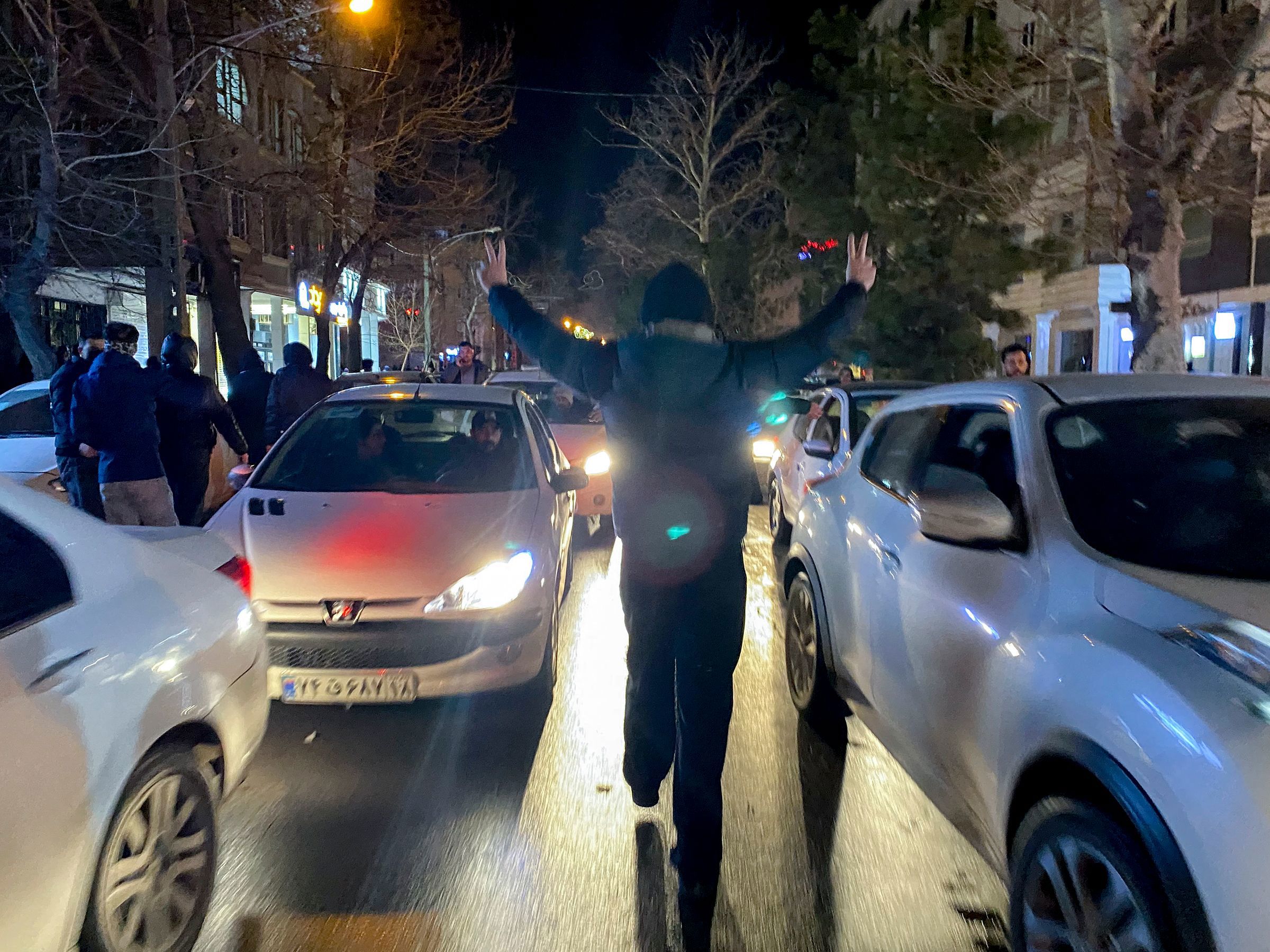 Burning debris lies in the middle of a street during unrest in Hamedan, Iran.