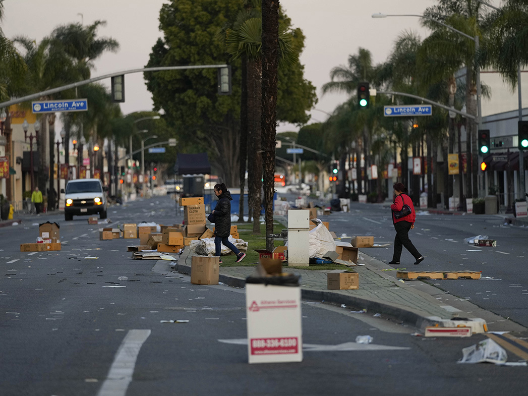 Los residentes caminan por el sitio del festival del Año Nuevo Lunar después de que fue cancelado debido a un tiroteo masivo cerca de Monterey Park, California.