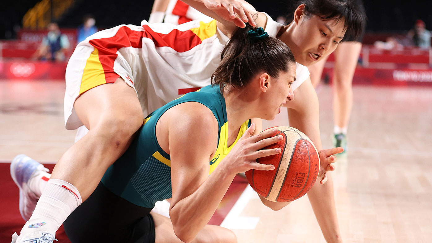 Yueru Li of Team China and Marianna Tolo of Team Australia fight for possession of the ball during the second half of a Women's Basketball Preliminary Round Group match between Australia and Puerto Rico at the Tokyo Olympics.