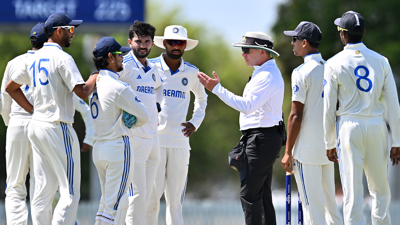 Umpire Shawn Craig speaking to India A players in Mackay.