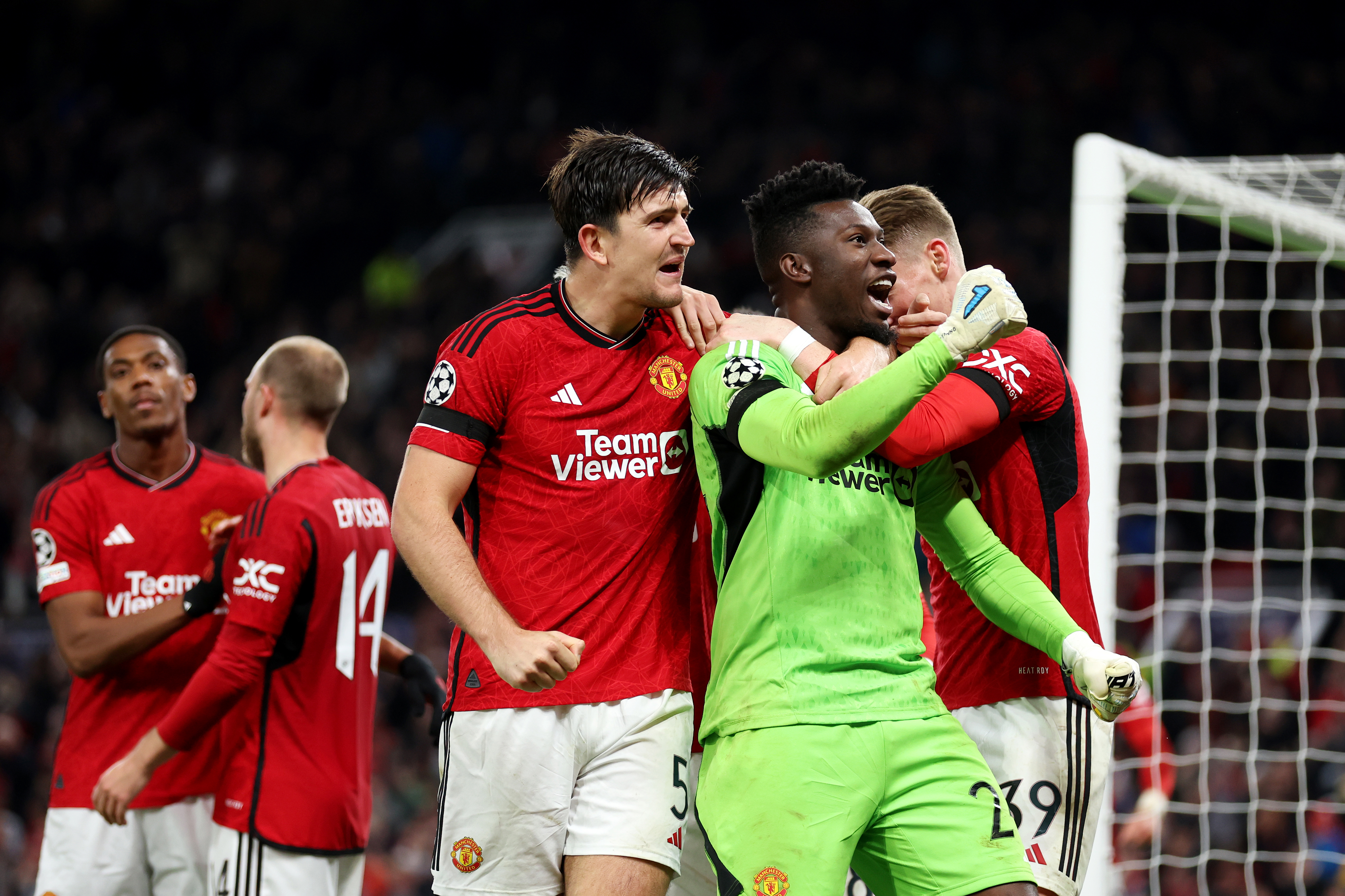 Andre Onana and Harry Maguire of Manchester United celebrate after saving a penalty from Jordan Larsson of FC Copenhagen during the UEFA Champions League match at Old Trafford.