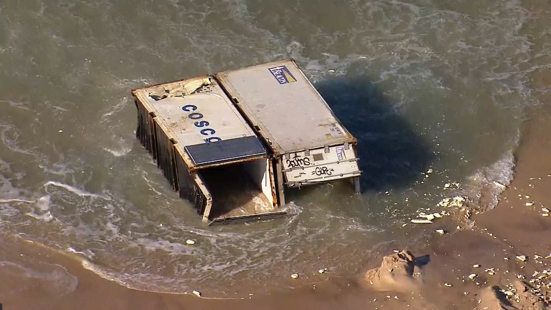 The containers are from the APL England that hit rough seas.