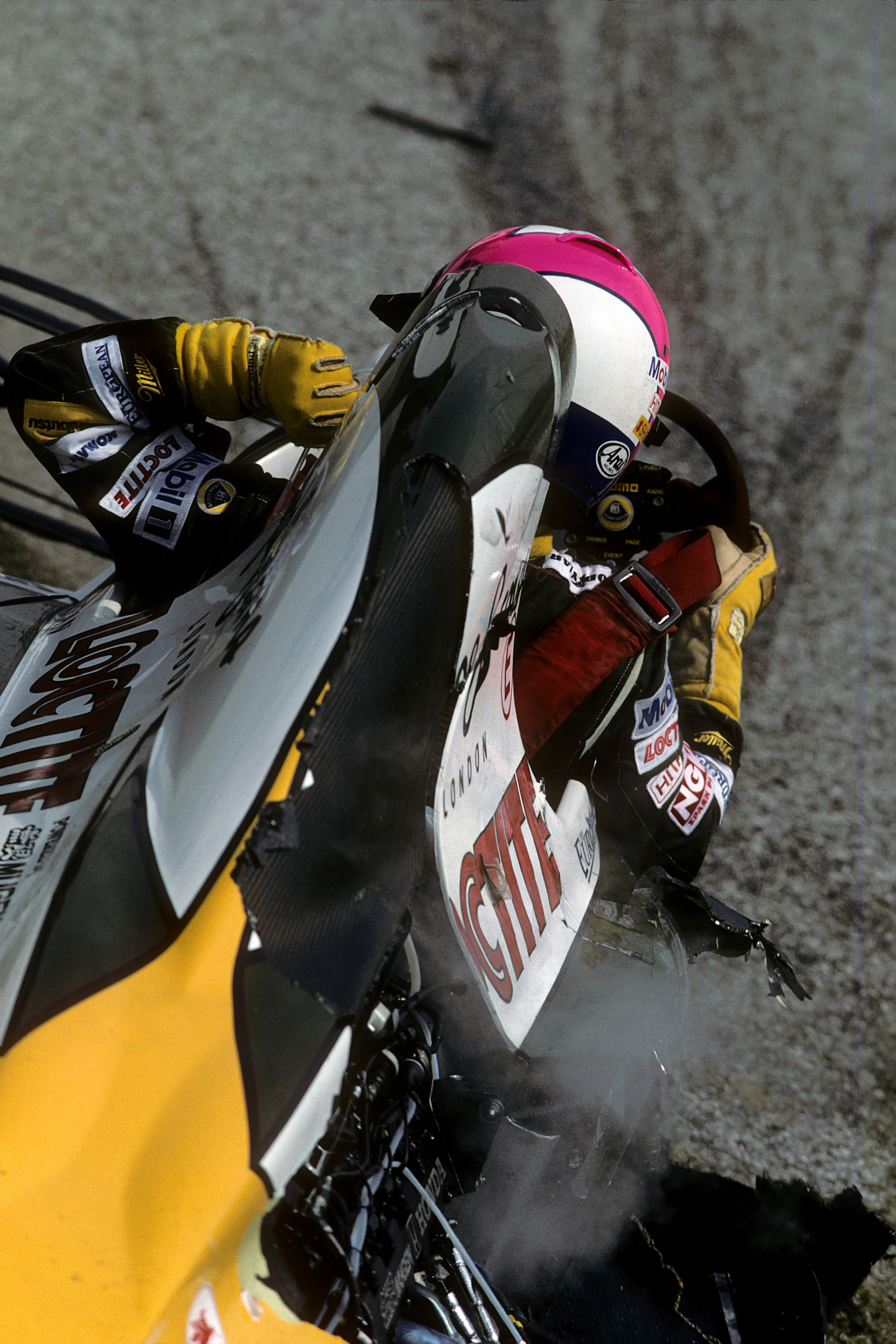 Pedro Lamy climbing out of his destroyed Lotus after a start line crash at the beginning of the 1994 San Marino Grand Prix.