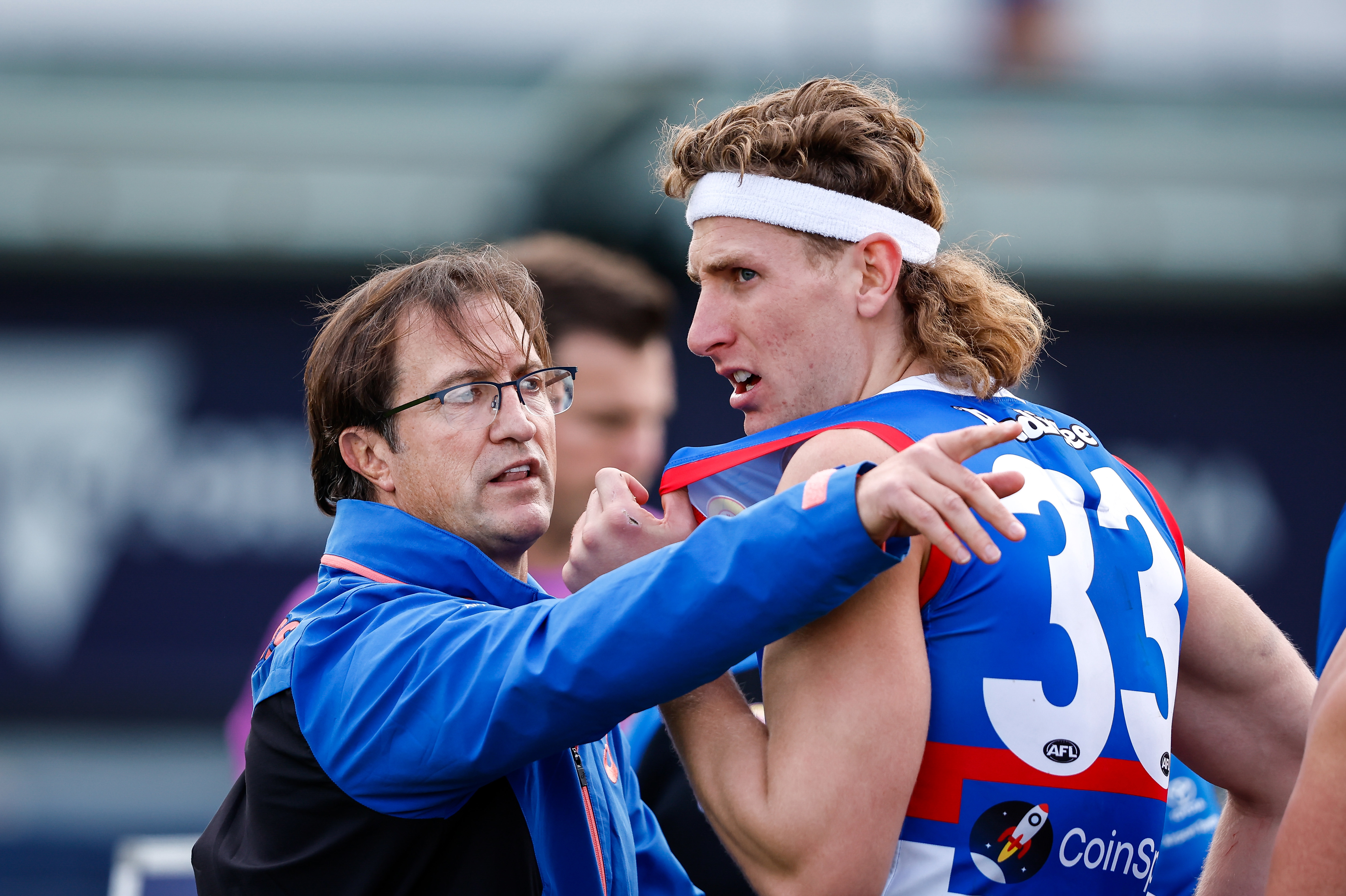 BALLARAT, AUSTRALIA - JULY 29: Luke Beveridge, Senior Coach of the Bulldogs speaks with Aaron Naughton of the Bulldogs during the 2023 AFL Round 20 match between the Western Bulldogs and the GWS GIANTS at Mars Stadium on July 29, 2023 in Ballarat, Australia. (Photo by Dylan Burns/AFL Photos via Getty Images)