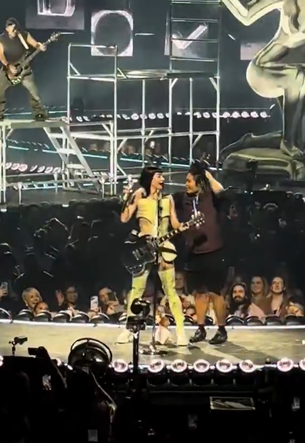 Wen danced on stage and put his arm around Perry during her performance of Hot N Cold.