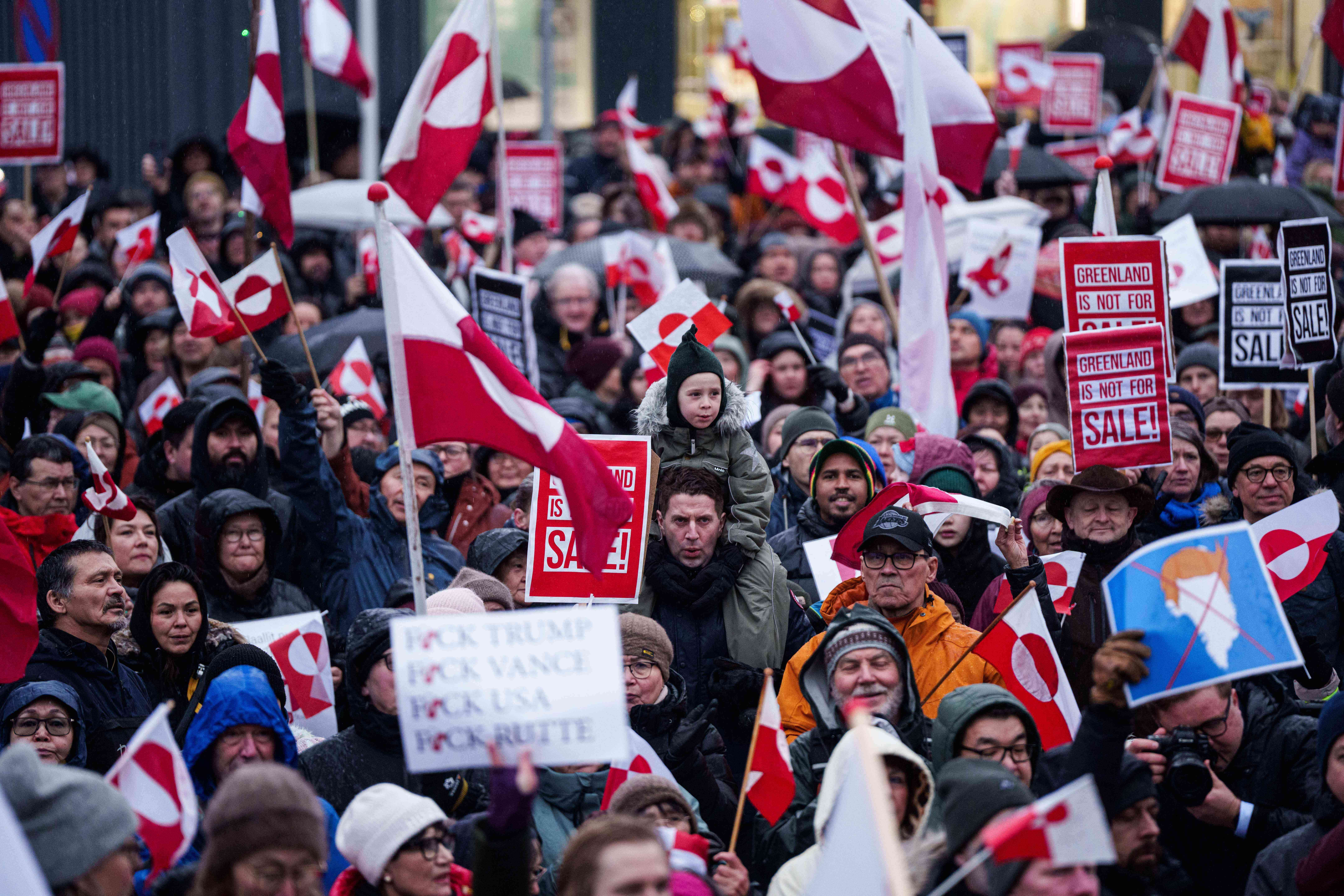 A crowd walks to the US consulate to protest against Trump's policy towards Greenland in Nuuk, Greenland, Saturday, Jan. 17, 2026. (AP Photo/Evgeniy Maloletka)