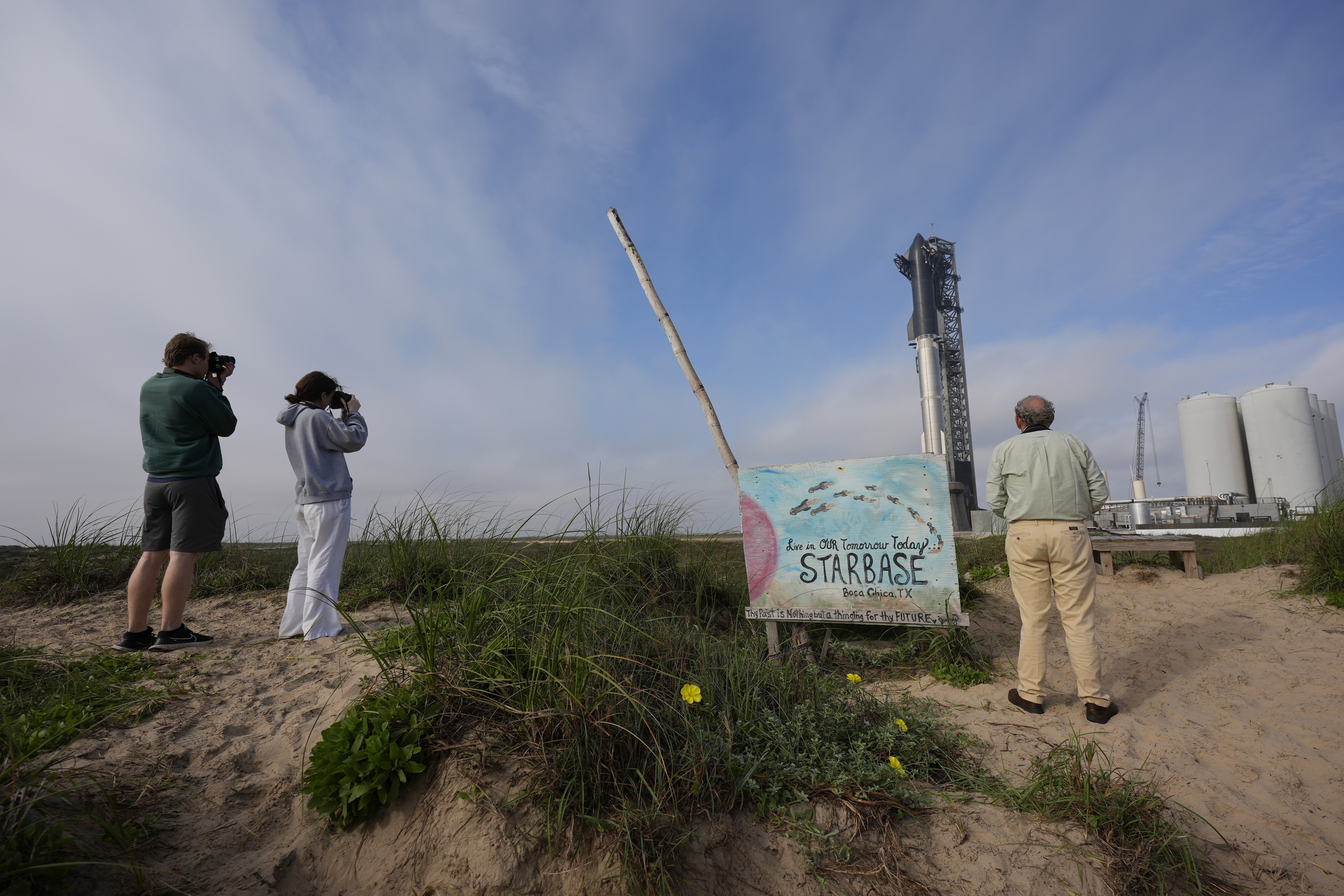 Visitors watch as SpaceX's mega rocket Starship is prepared for it's third test flight from Starbase in Boca Chica, Texas, Wednesday, March 13, 2024.