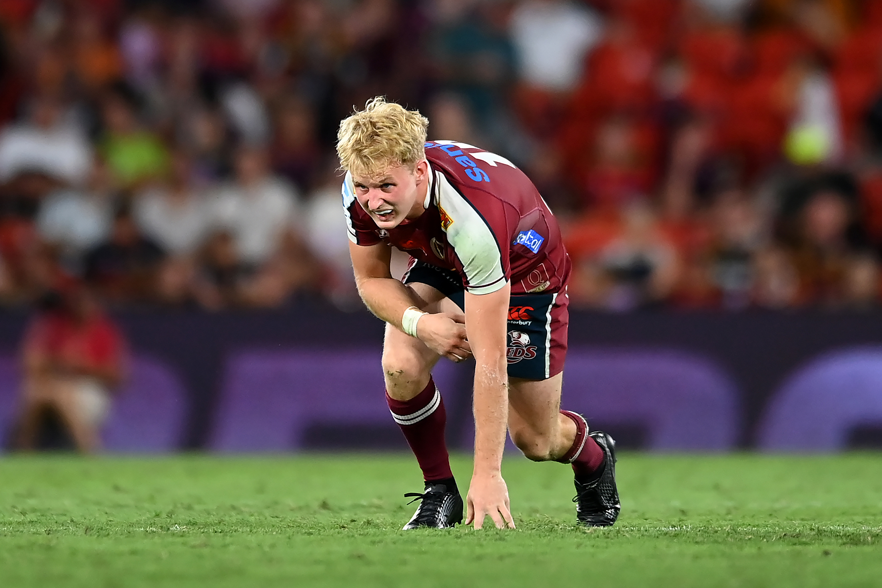 Tom Lynagh of the Reds reacts after a tackle during the round three Super Rugby Pacific match against the Chiefs.