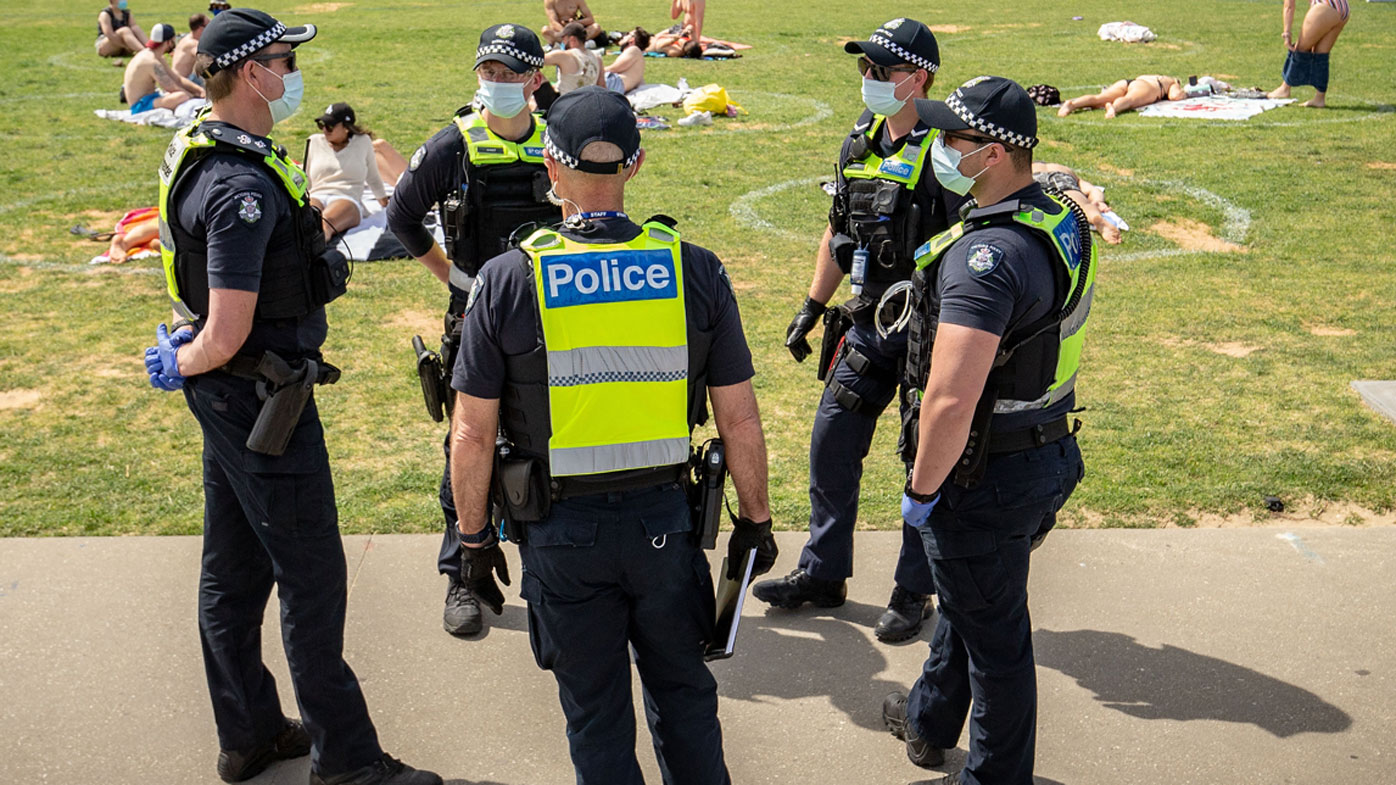 Victoria Police patrol at St Kilda beach.