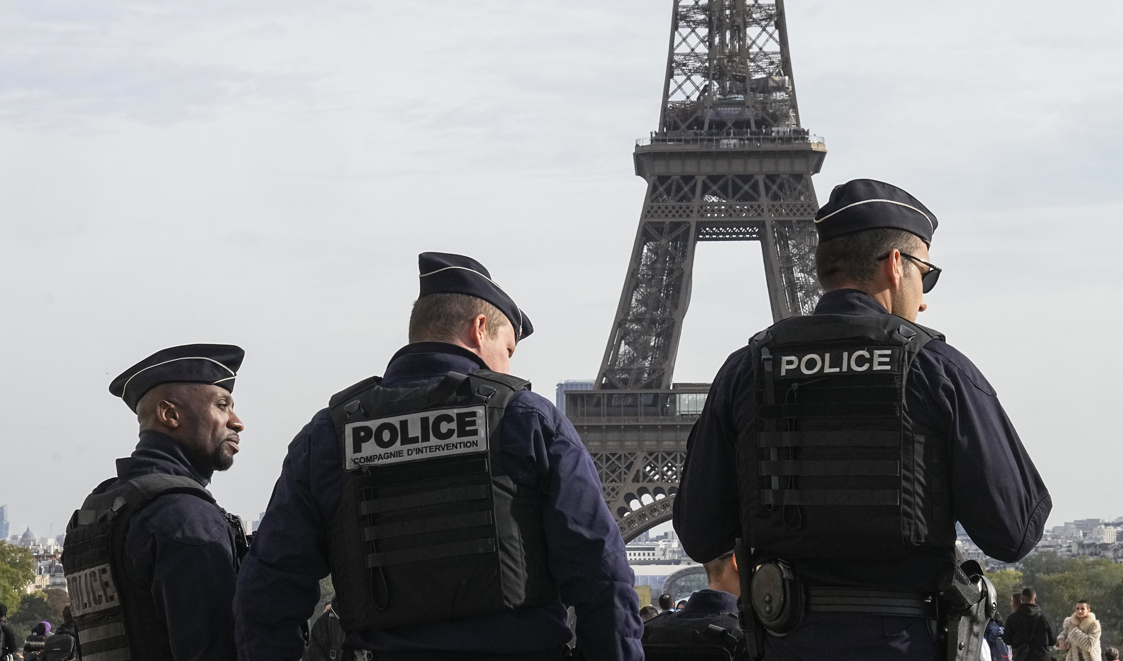 Police officers patrol the Trocadero plaza near the Eiffel Tower in Paris, Tuesday, Oct. 17, 2023.