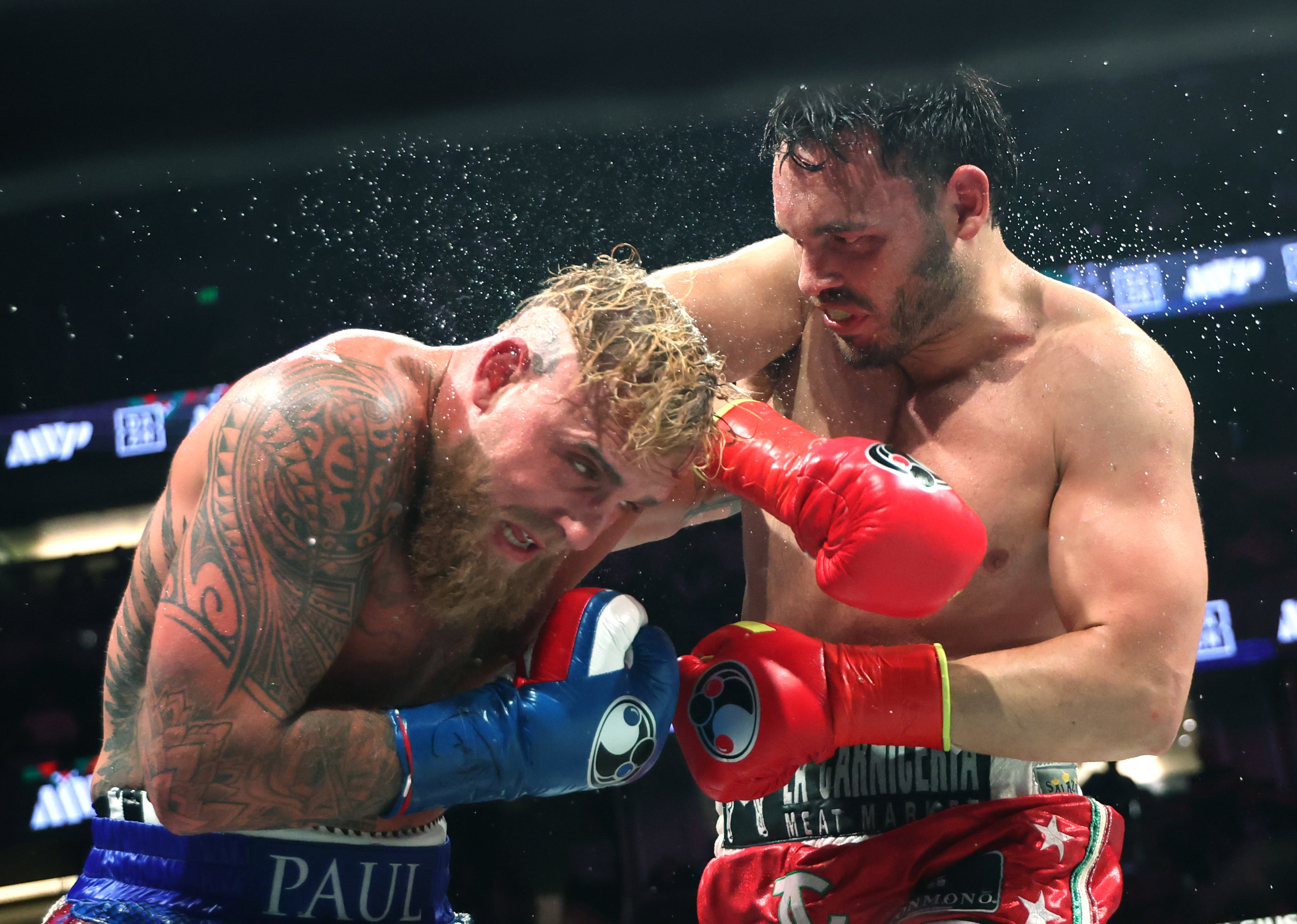 Julio Cesar Chavez Jr (right) punches Jake Paul on his way to losing.