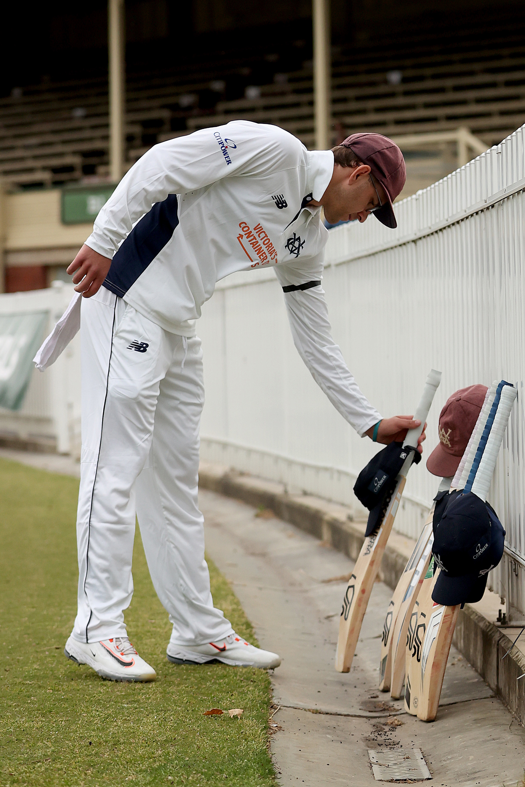 Todd Murphy of Victoria places his bats and cap in honour of the late Ben Austin during a minutes silence and tribute on day four of the Sheffield Shield  match between Victoria and Tasmania at CitiPower Centre, on October 31, 2025, in Melbourne, Australia. 