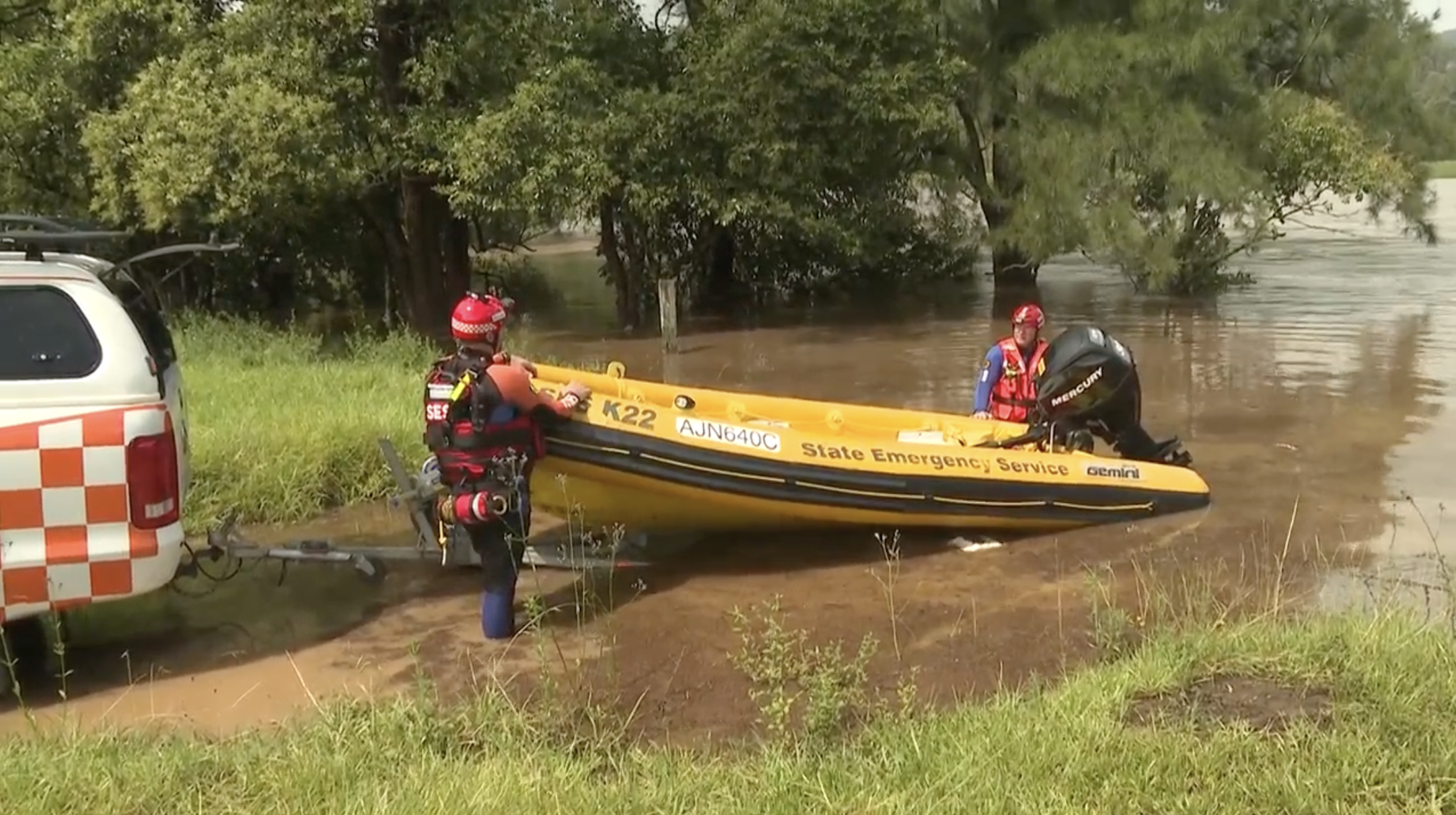 A search is under way after a car was swept off a road by floodwaters in Limpinwood, NSW