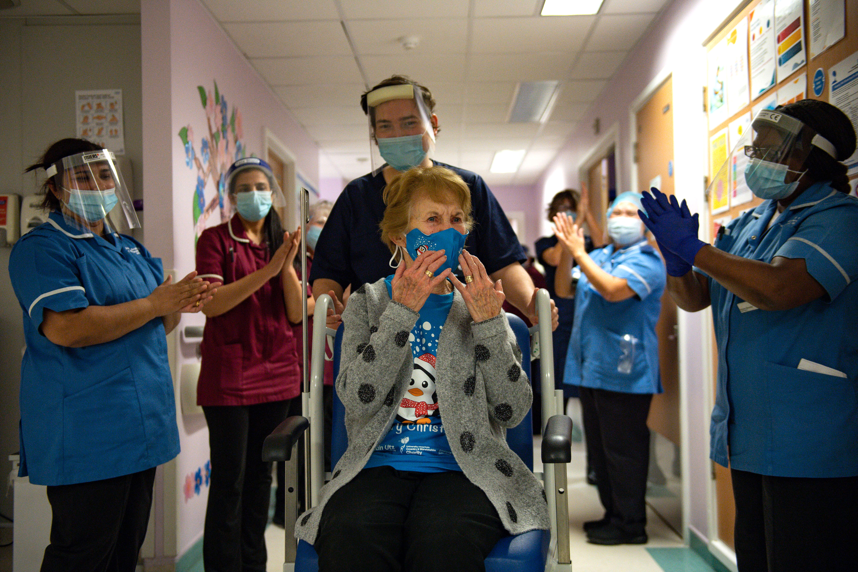 Margaret Keenan, 90, is applauded back onto her ward by nurses, after receiving the first Pfizer covid-19 vaccine at University Hospital Coventry.