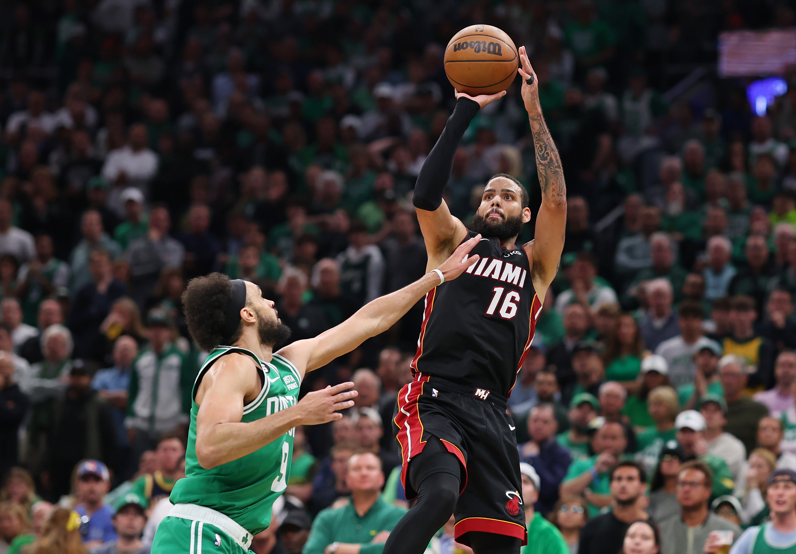 BOSTON, MASSACHUSETTS - MAY 29: Caleb Martin #16 of the Miami Heat attempts a three point basket against Derrick White #9 of the Boston Celtics during the third quarter in game seven of the Eastern Conference Finals at TD Garden on May 29, 2023 in Boston, Massachusetts. NOTE TO USER: User expressly acknowledges and agrees that, by downloading and or using this photograph, User is consenting to the terms and conditions of the Getty Images License Agreement. (Photo by Maddie Meyer/Getty Images)