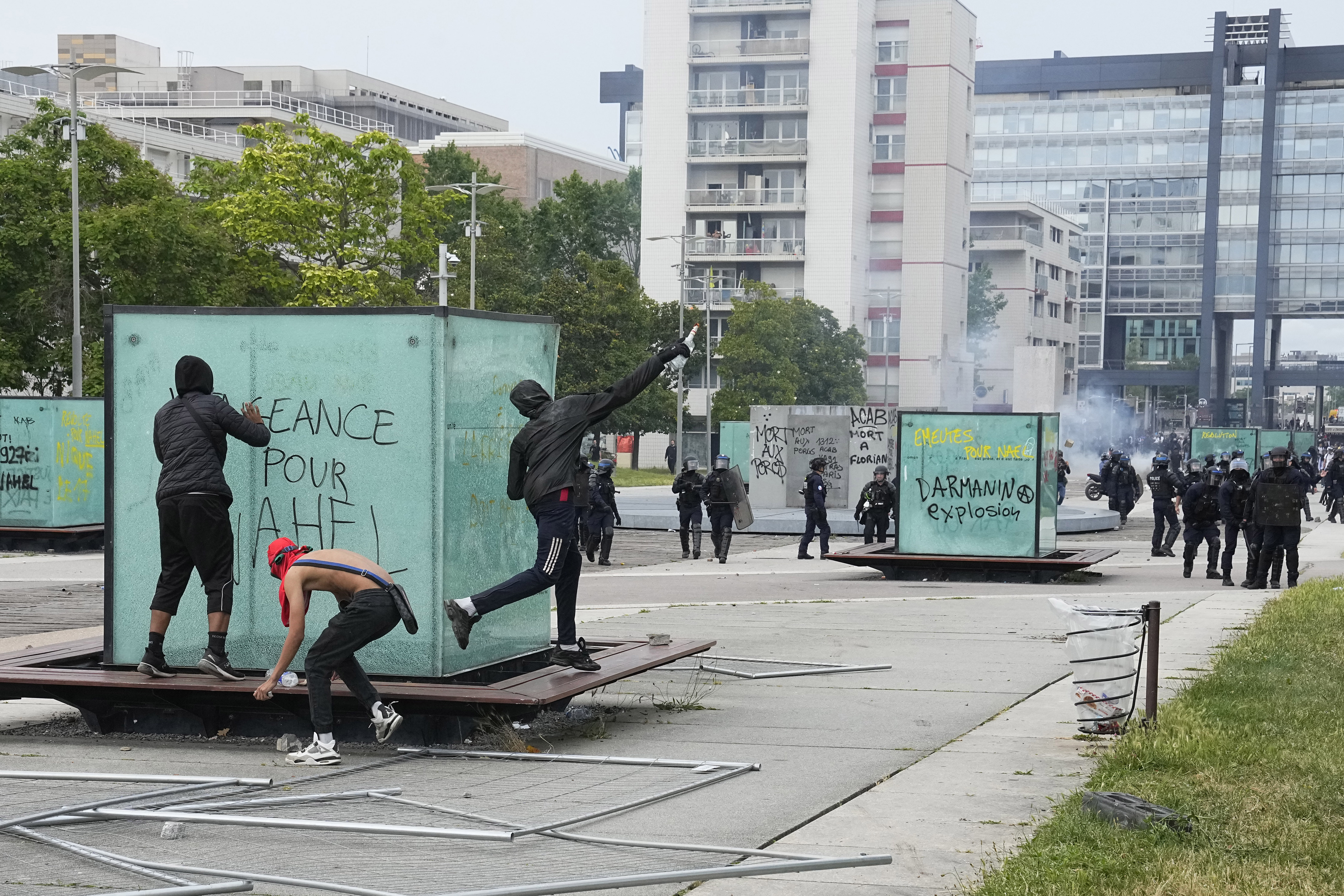 Youth throws a bottle to police forces during riots Thursday, June 29, 2023 in Nanterre, outside Paris. 