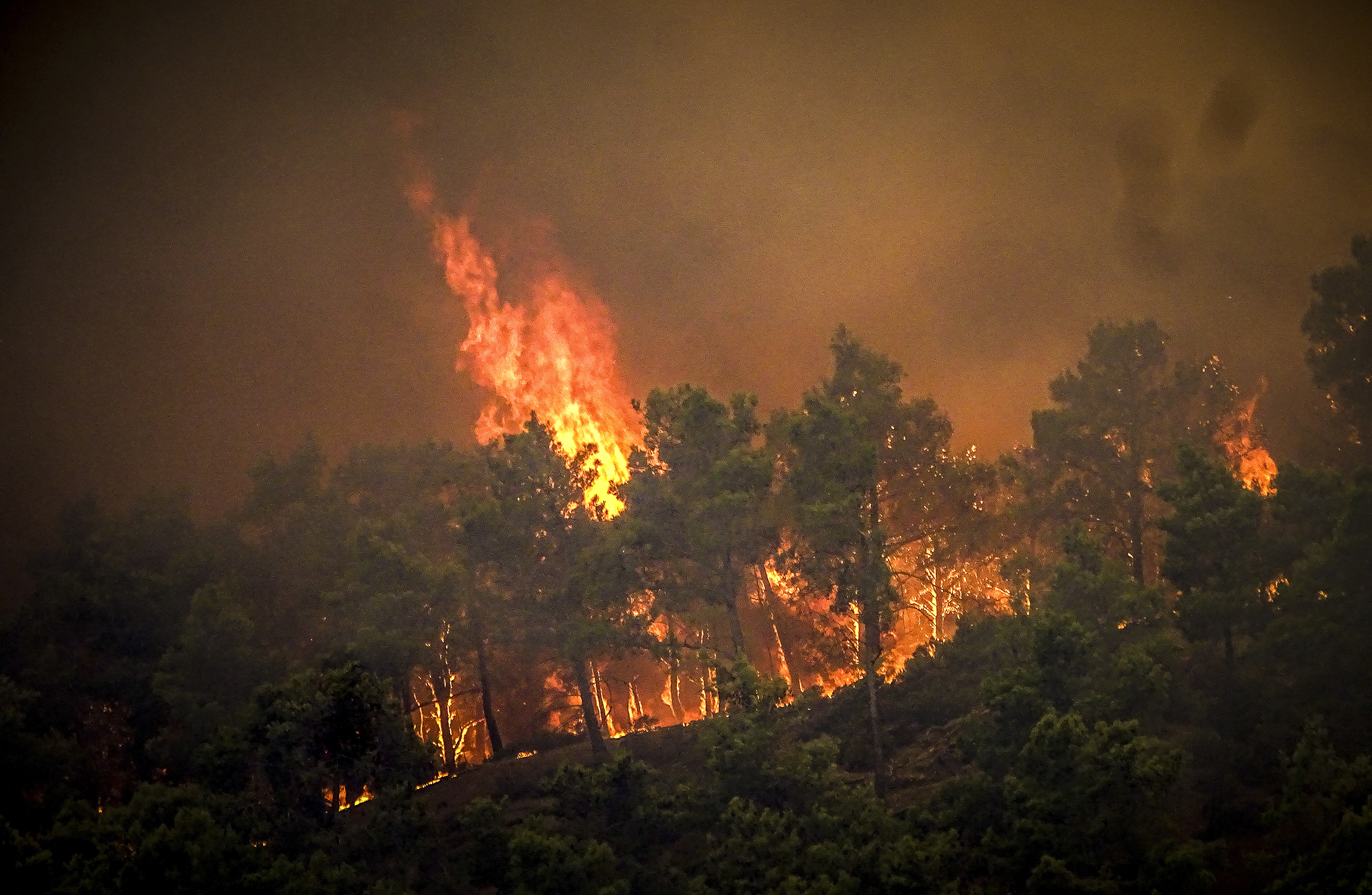 Flames rise during a forest fire on the island of Rhodes, Greece, Saturday, July 22, 2023. 