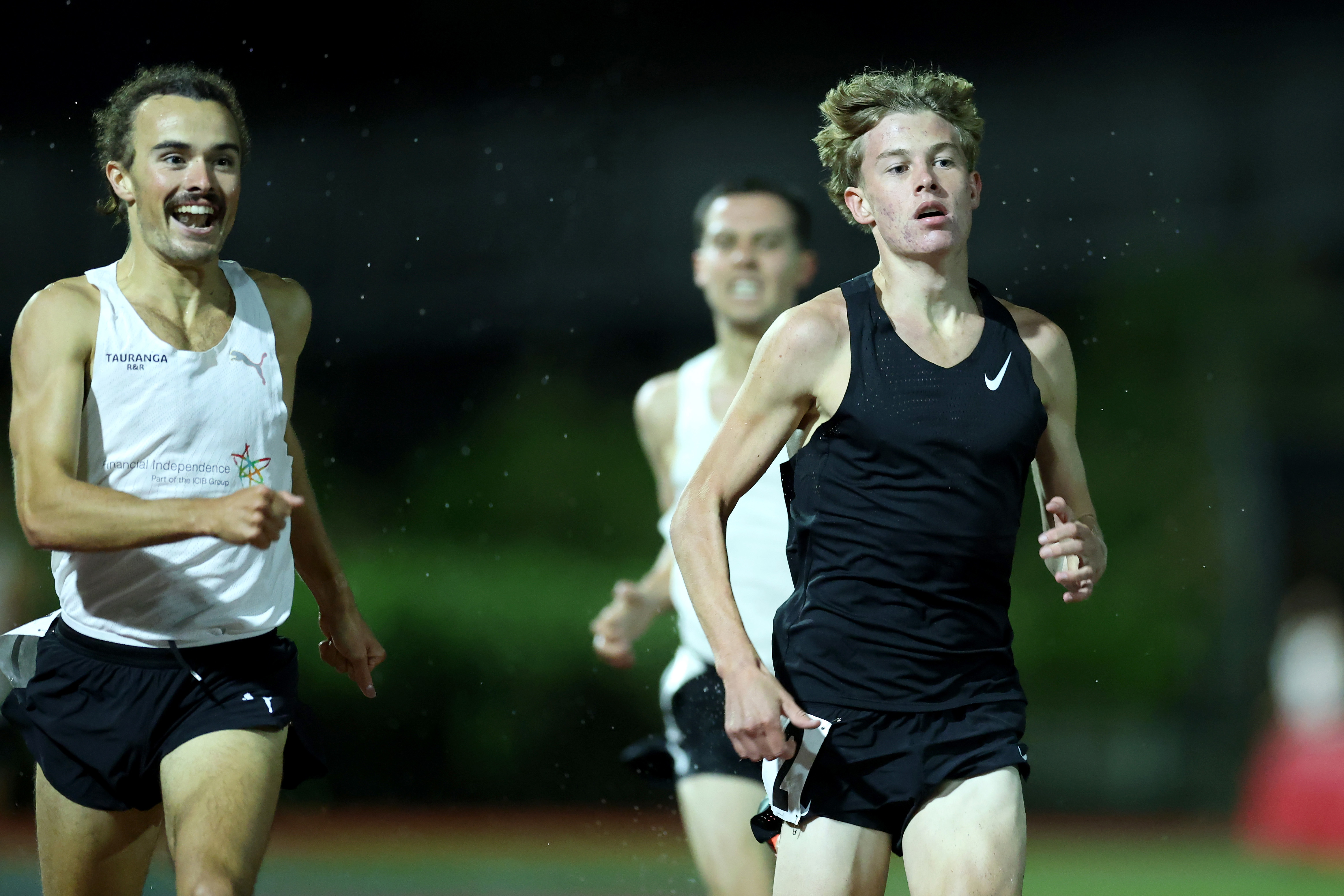 Sam Tanner (left) cheering on fellow Kiwi Sam Ruthe as the 15-year-old becomes the youngest sub-four-minute miler in the world in history.