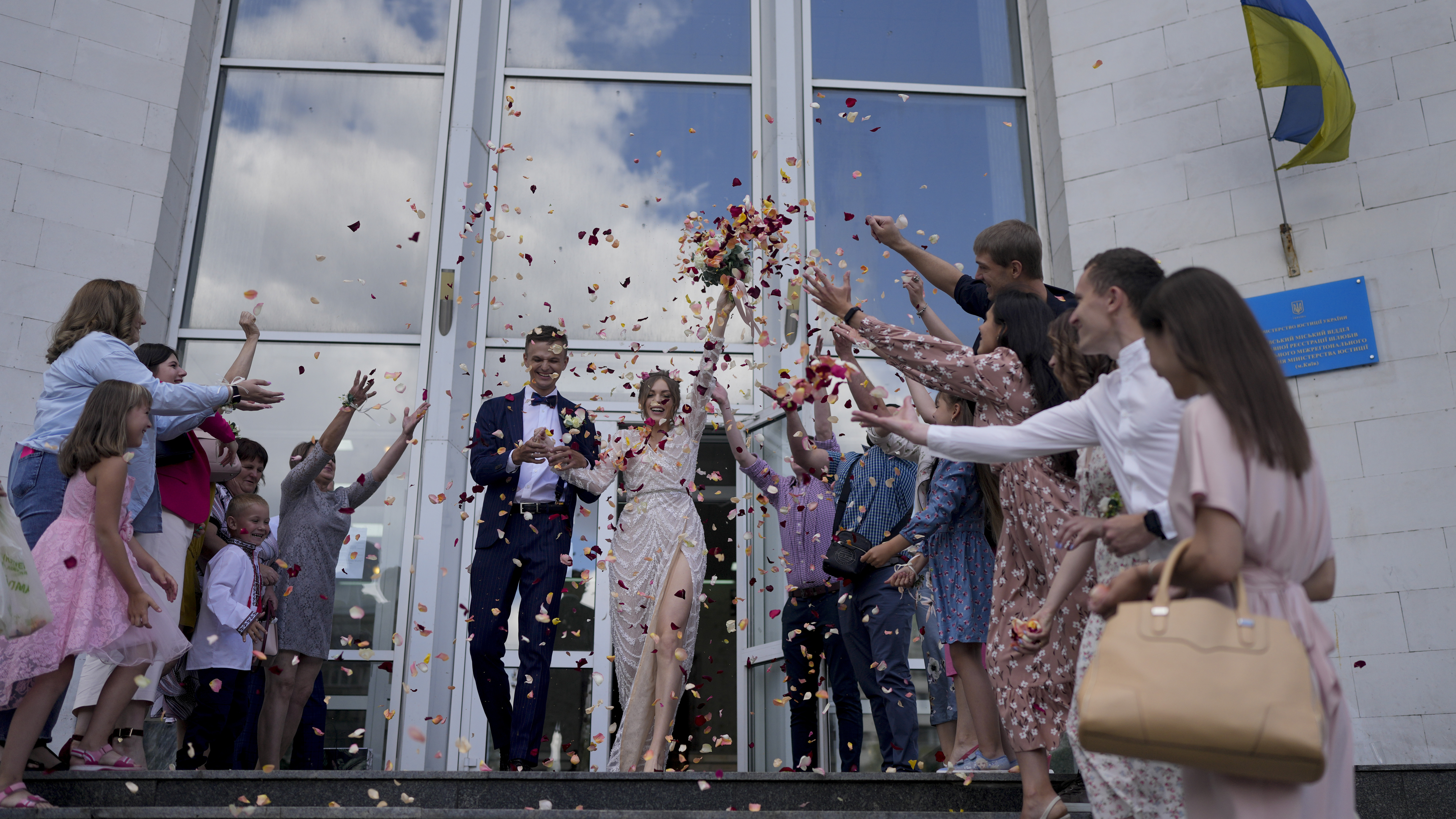 Denys Voznyi and Anna Karpenko leave after getting married in Kyiv.