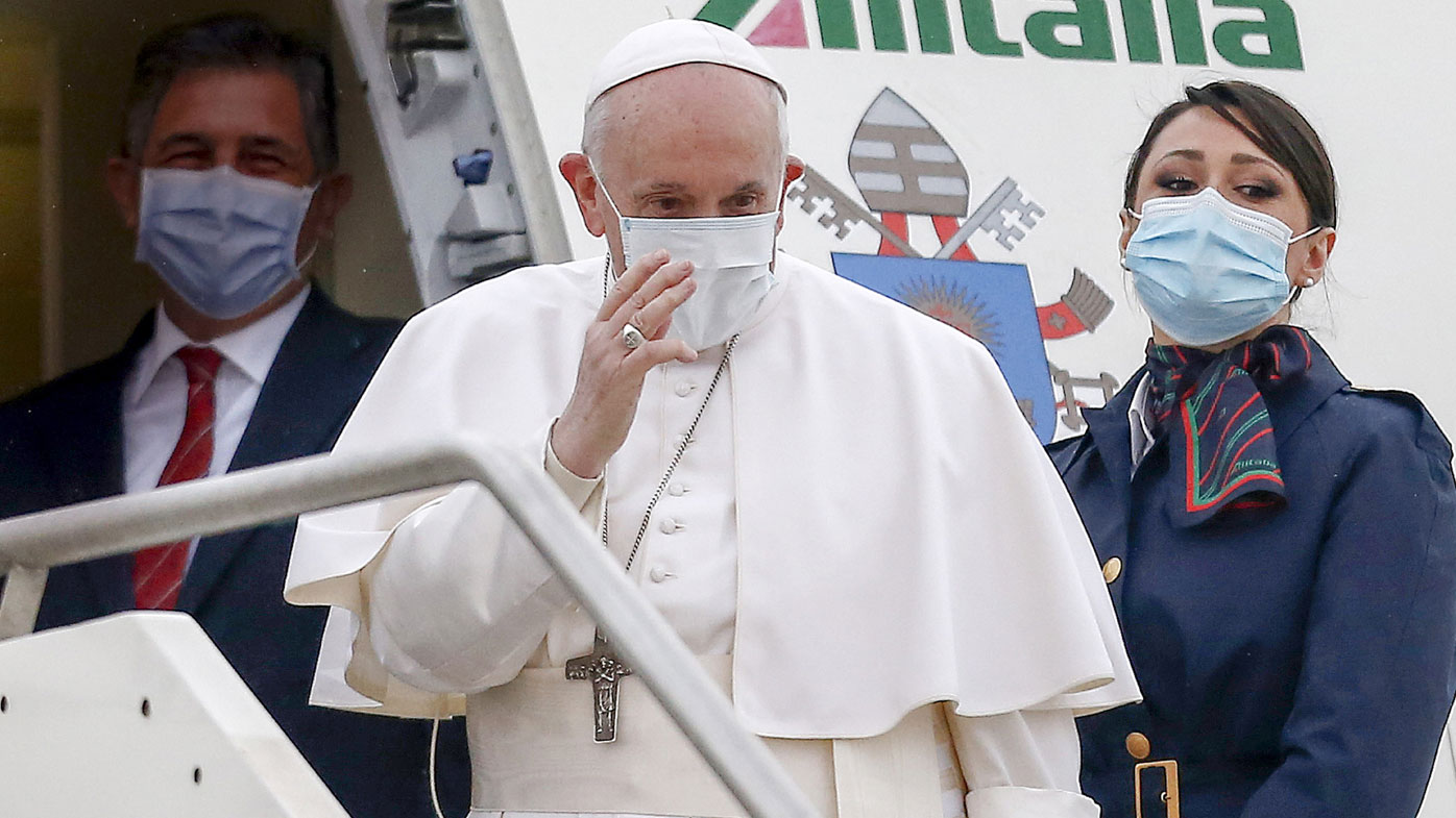 Pope Francis gives his blessing as he prepares to leave from Fiumicino's International airport Leonardo da Vinci, near Rome, for Baghdad, Iraq, Friday, March 5, 2021.