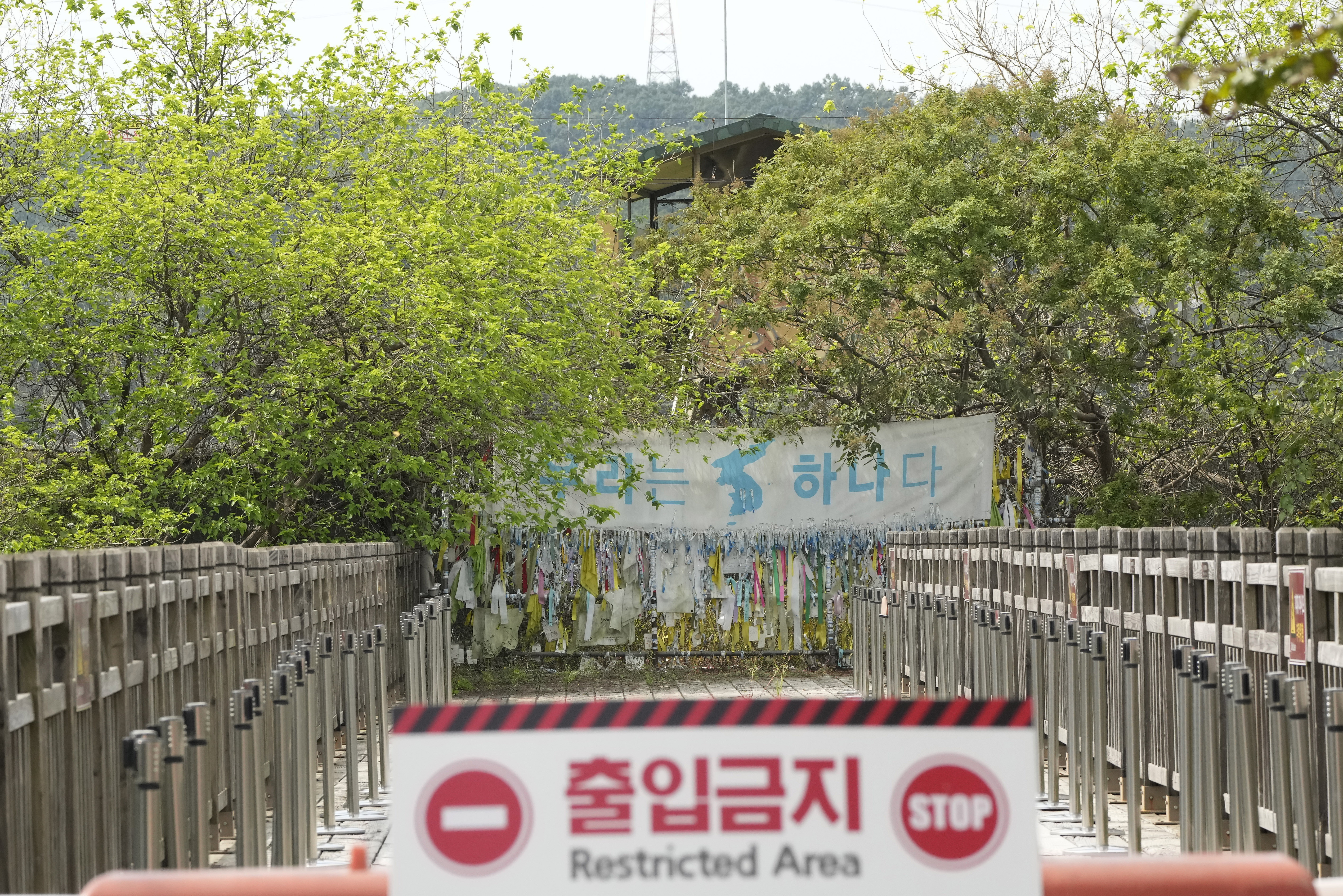 A banner and ribbons wishing reunification of the two Koreas are displayed on the wire fence at the Imjingak Pavilion in Paju, near the border with North Korea.