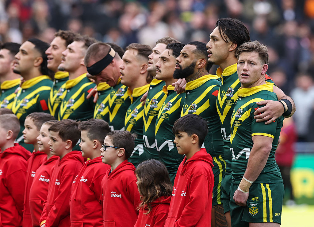 Australia's captain Harry Grant leads his side as they sing the national anthem.