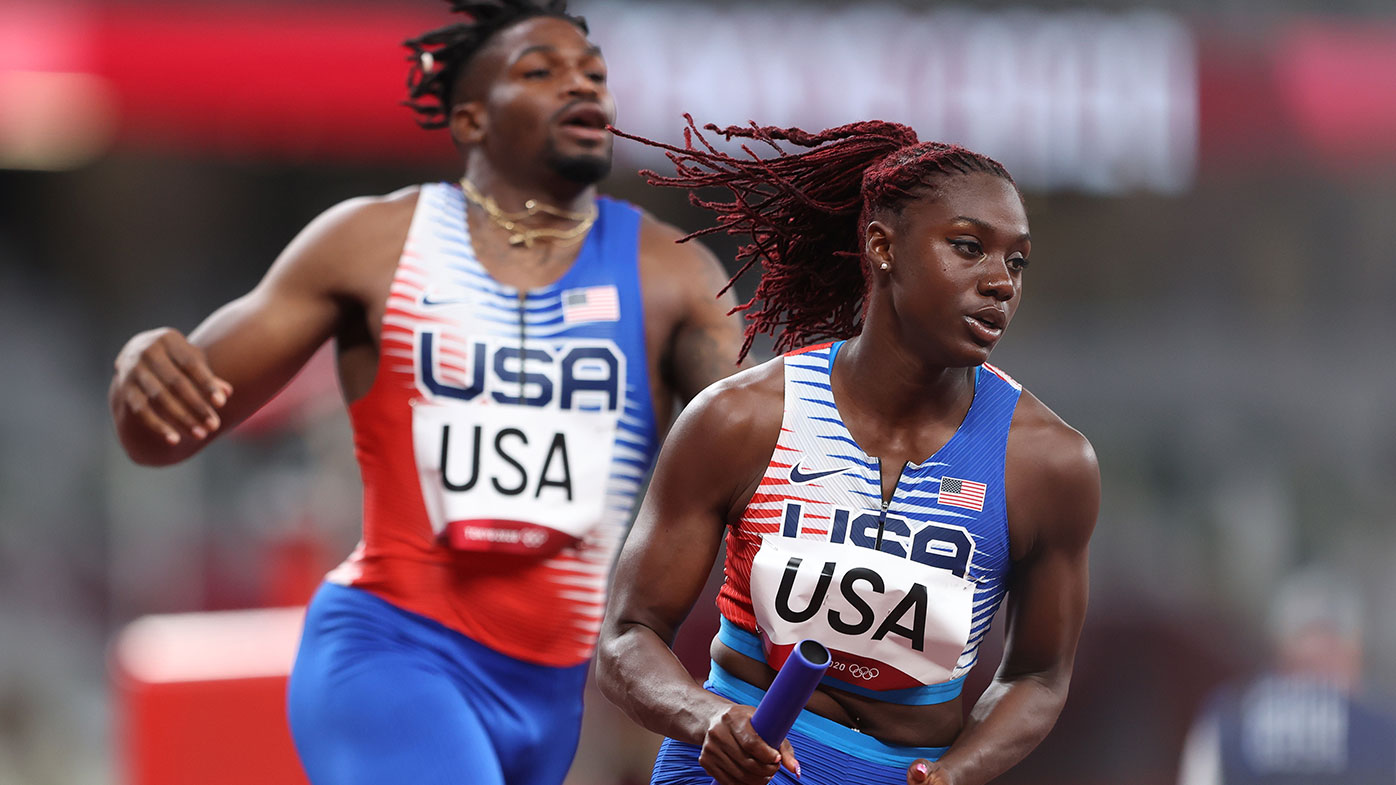 ...carries the baton while competing in the 4 × 400 Relay Mixed Round 1 on ...