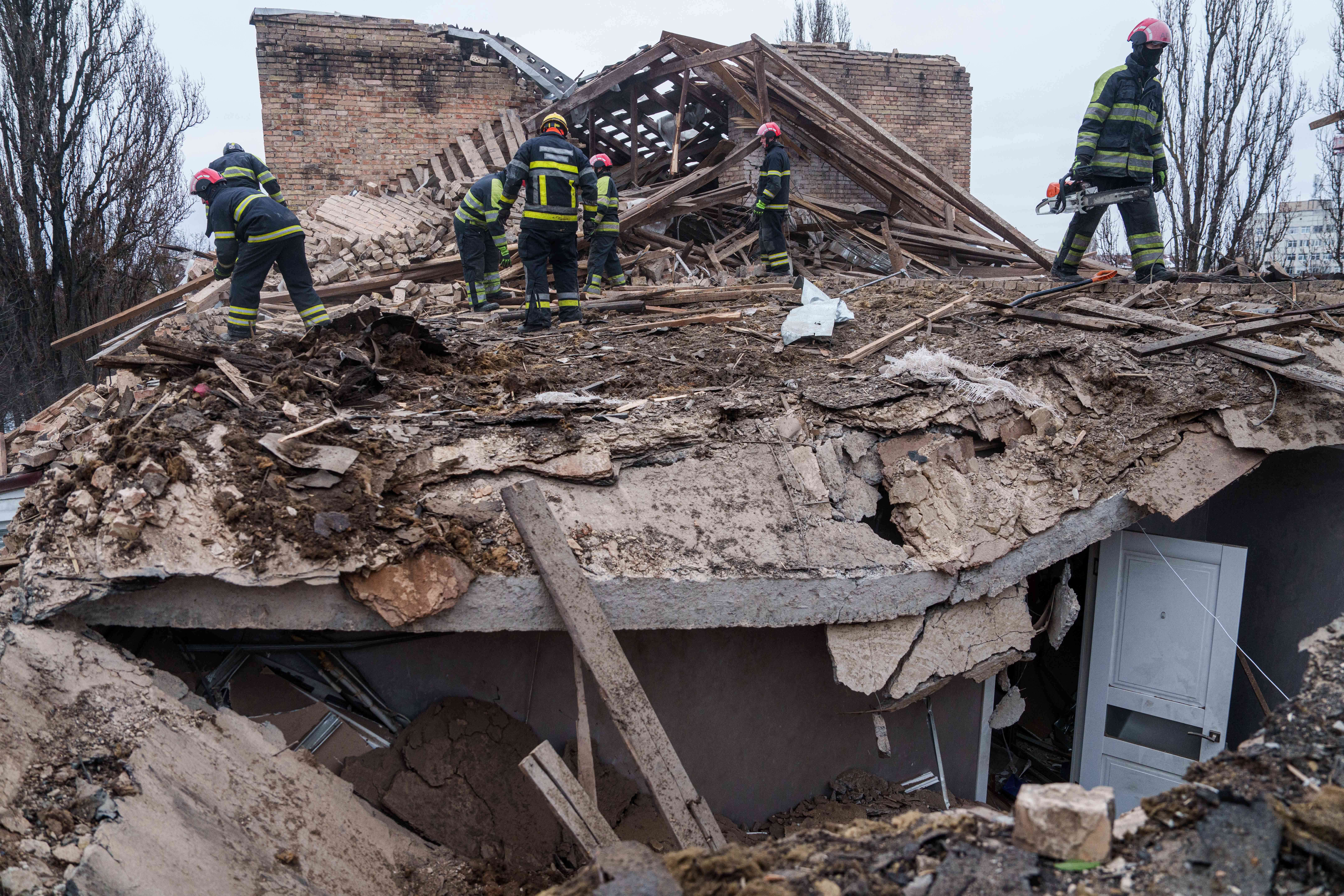 Rescue workers clear the rubble at the roof of apartment building damaged after a Russian strike on Kyiv, Ukraine, on Saturday, Dec. 27, 2025. (AP Photo/Evgeniy Maloletka)